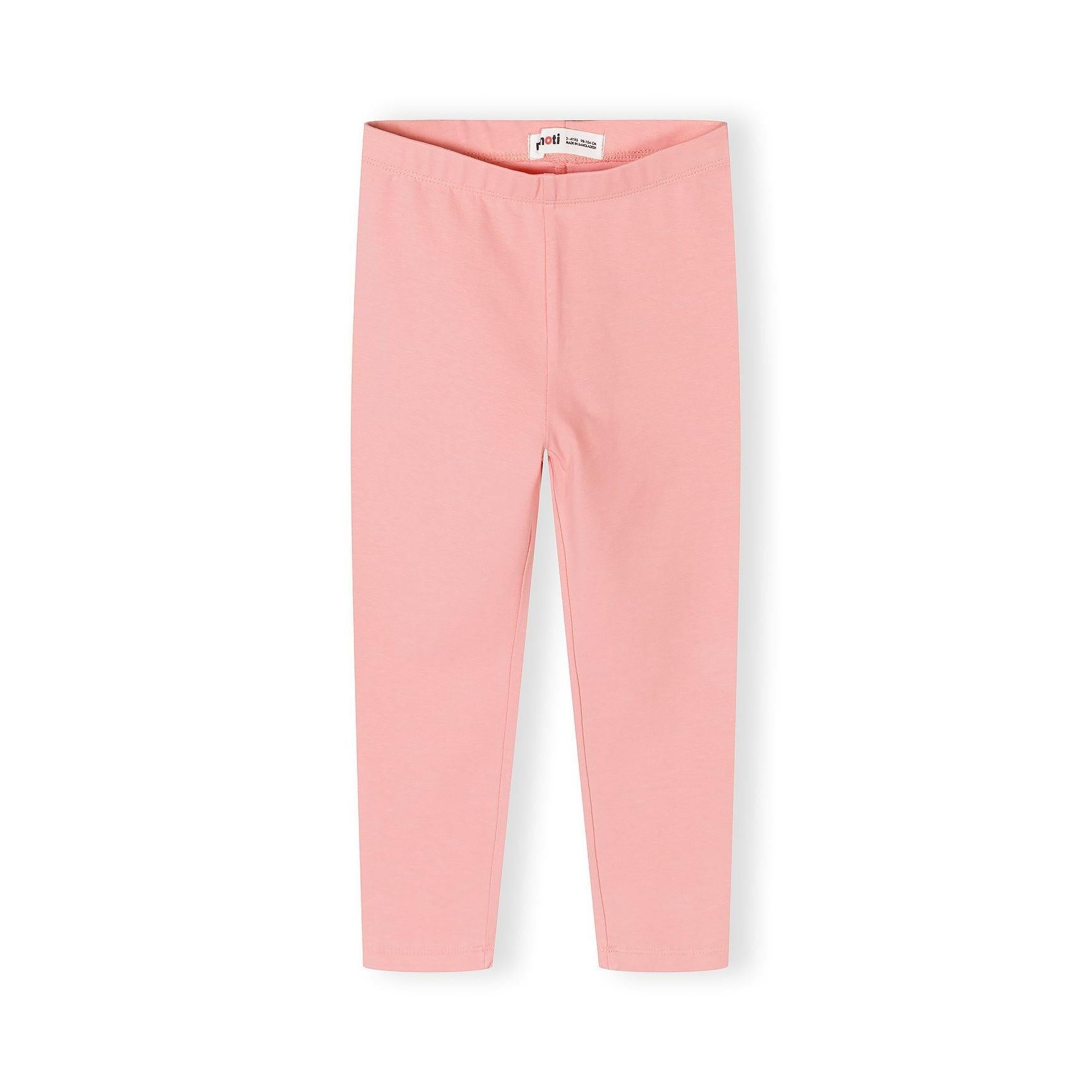 Close up detail of coral pink leggings showing soft fabric texture and comfortable elastic waistband construction