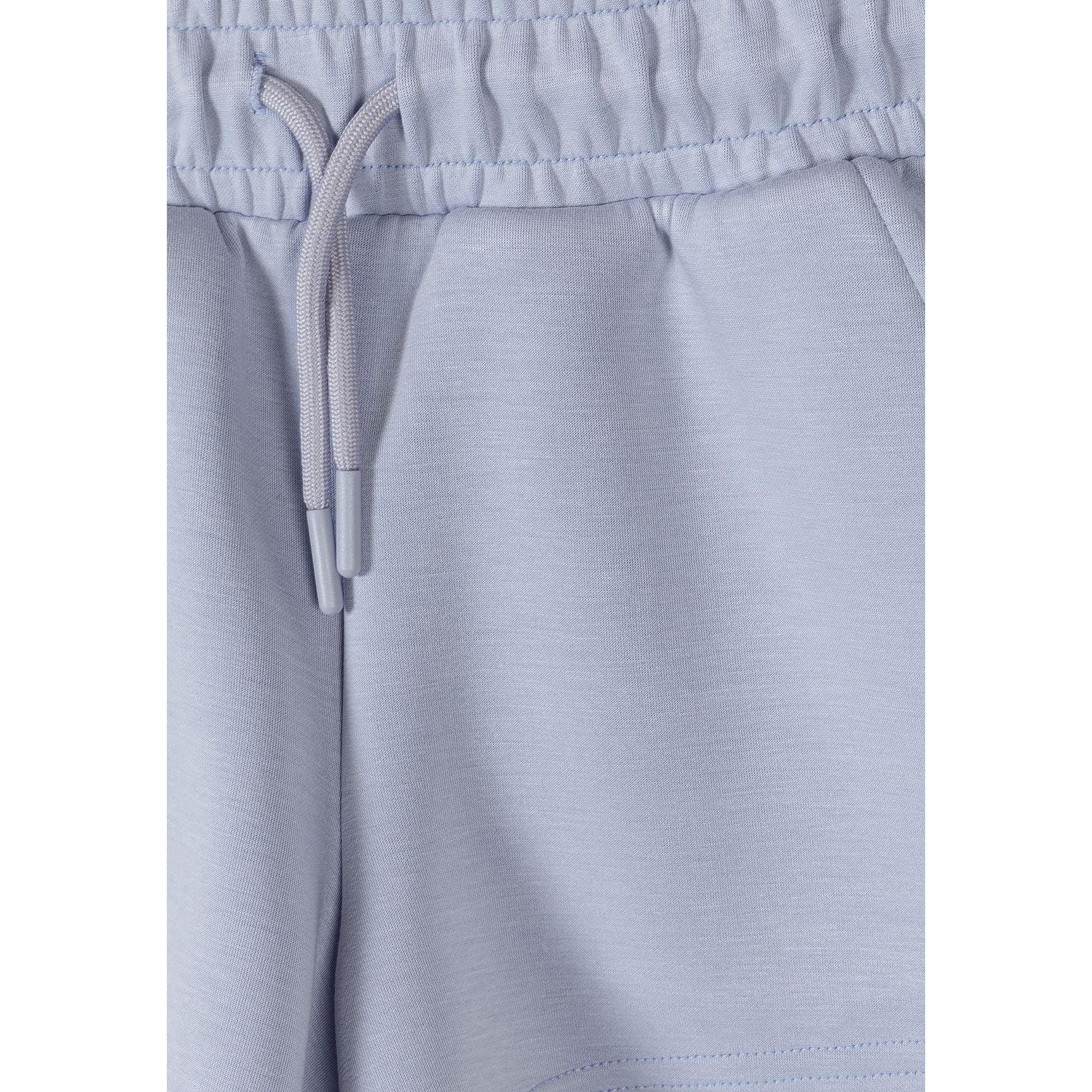Close-up detail of lavender shorts showing elasticated waistband with drawstring ties