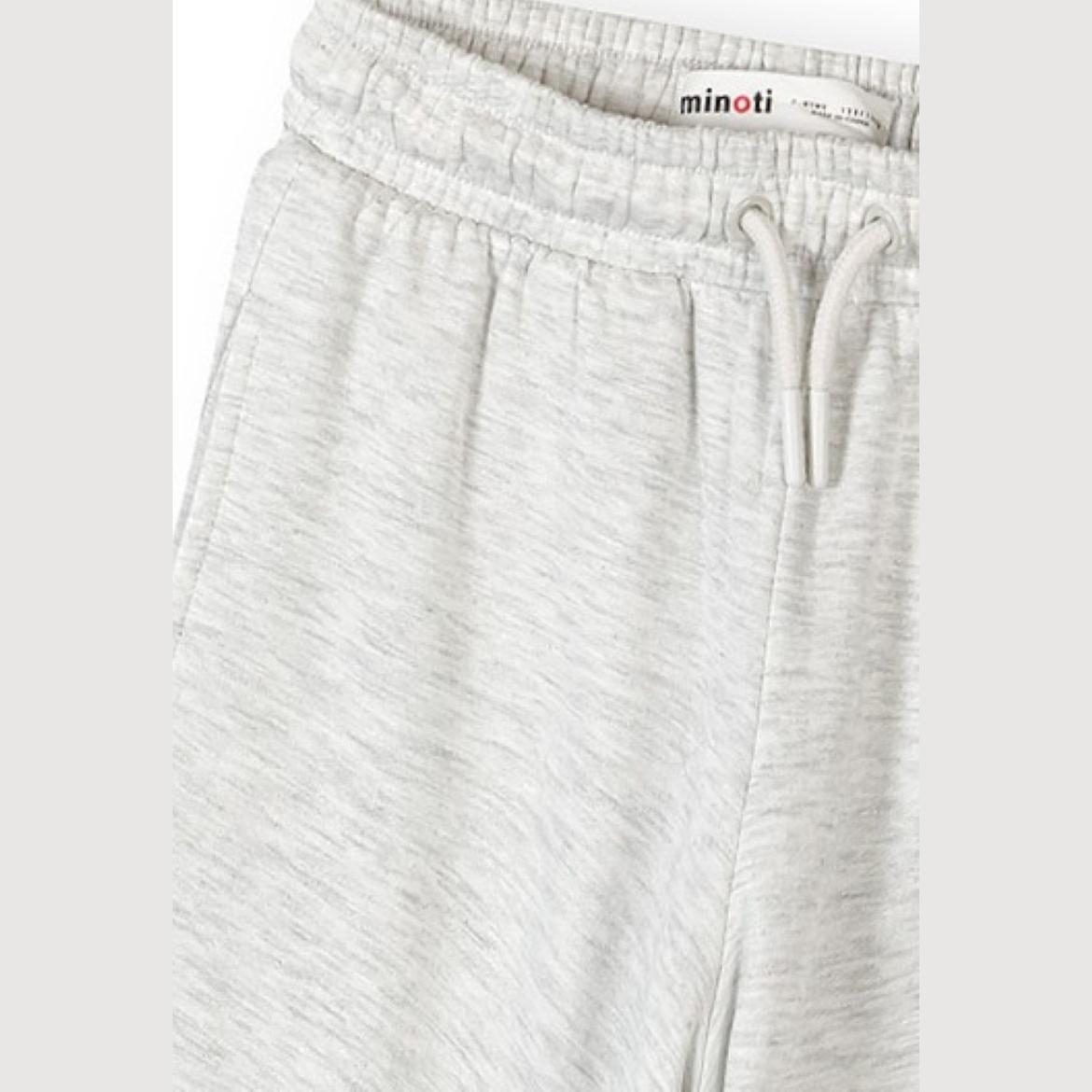 Close-up detail of light grey joggers showing elasticated waistband with white drawstring and Minoti brand label