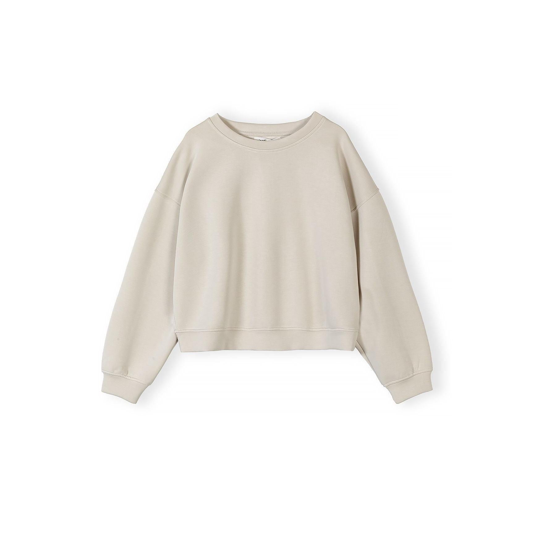 Close-up of beige shorts showing elasticated waistband with drawstring and side pockets