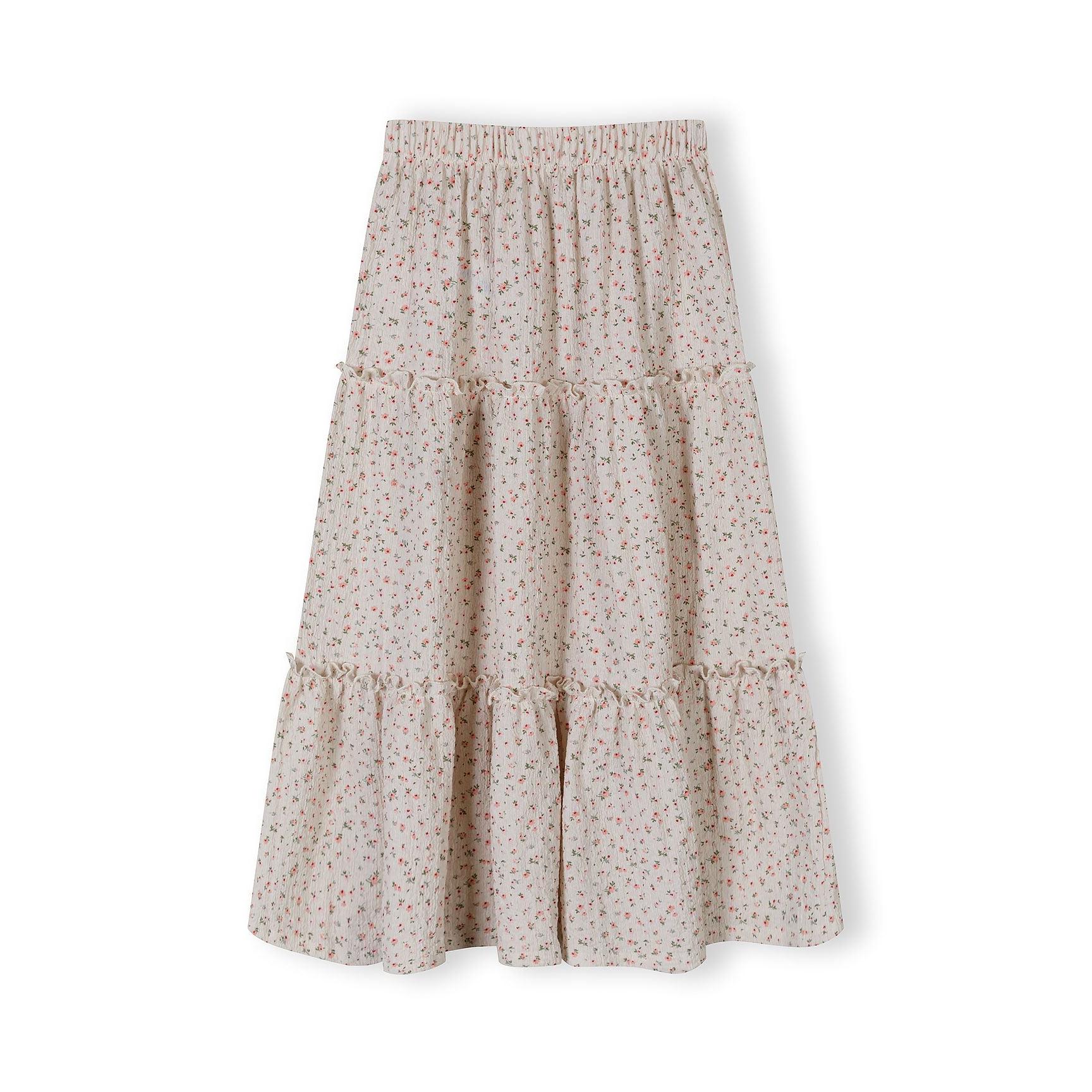 Back view of cream floral maxi skirt showing tiered layers and gathered waistband detail