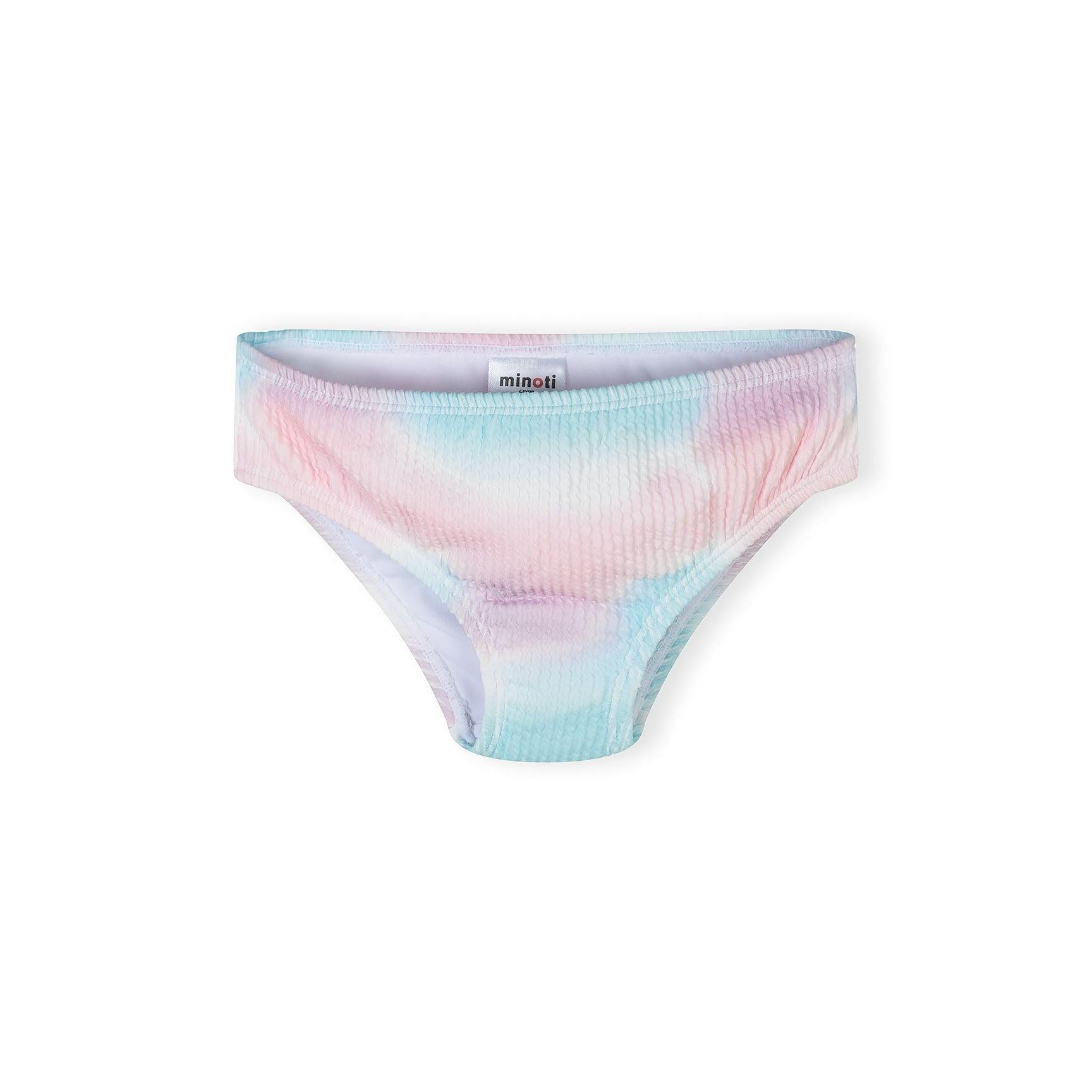 Close-up of ribbed texture bikini bottom in pink and blue tie-dye pattern on white background, showing Minoti brand label at waistband