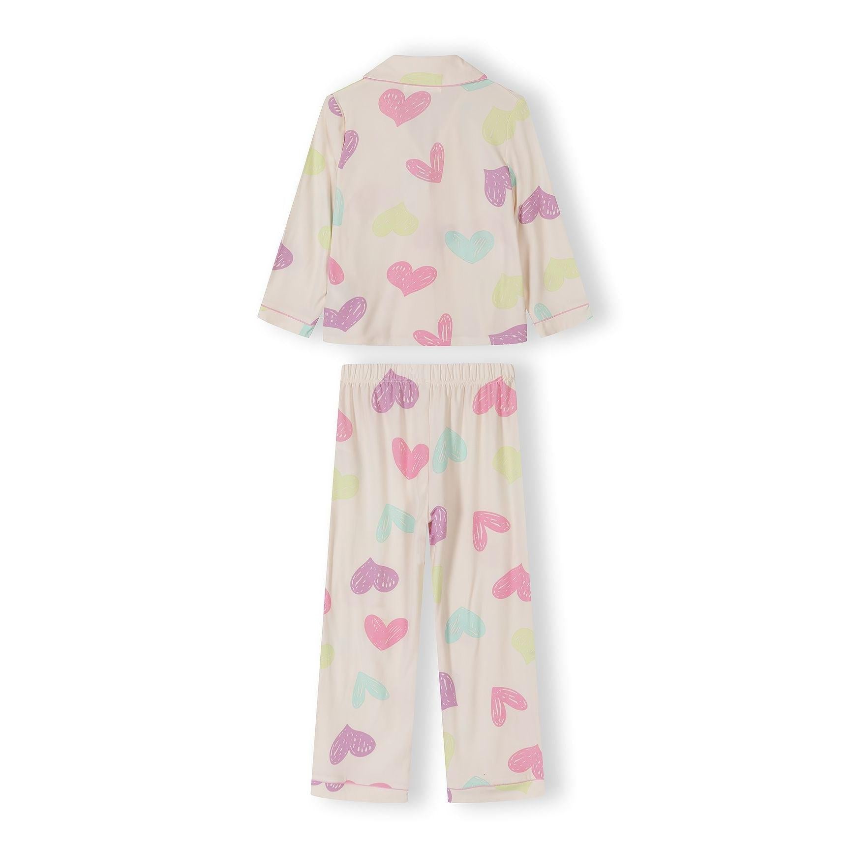 Close-up of pink pyjama top with heart print showing long sleeves, button front closure and chest pocket detail