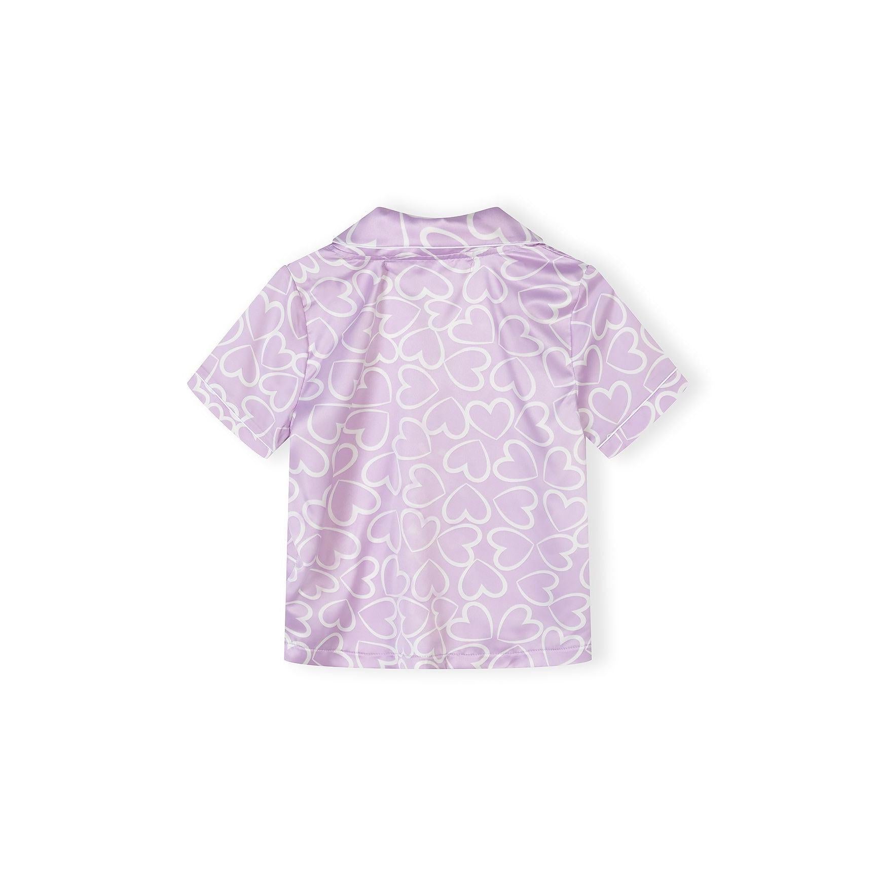 Detail shot of pyjama shorts waistband showing elastic construction and Minoti brand label on lilac background