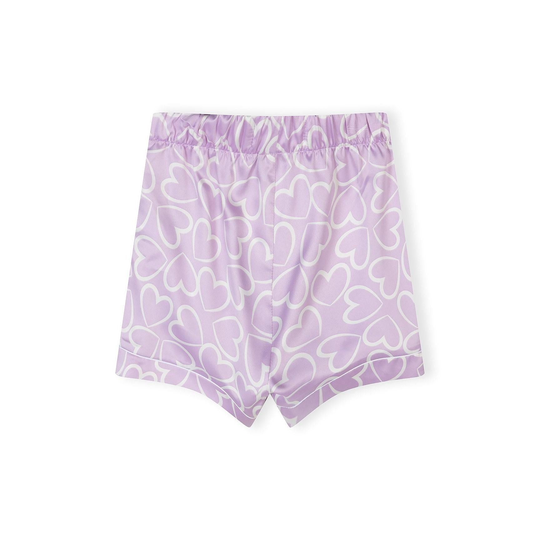 Detail shot of pyjama shorts waistband showing elastic construction and Minoti brand label on lilac background