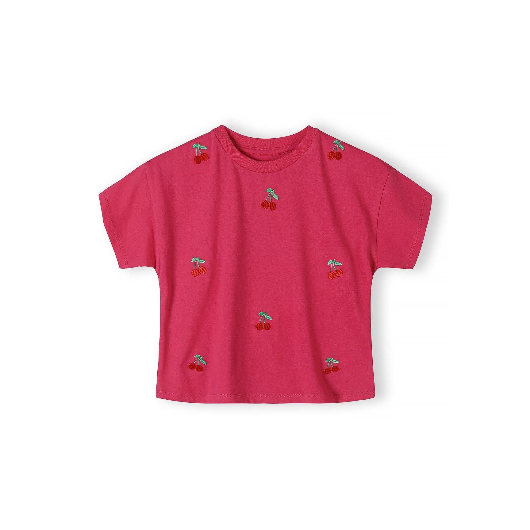 Pink cotton t-shirt with cherry embroidery laid flat against white background, showing front view with scattered small red cherry motifs across the fabric