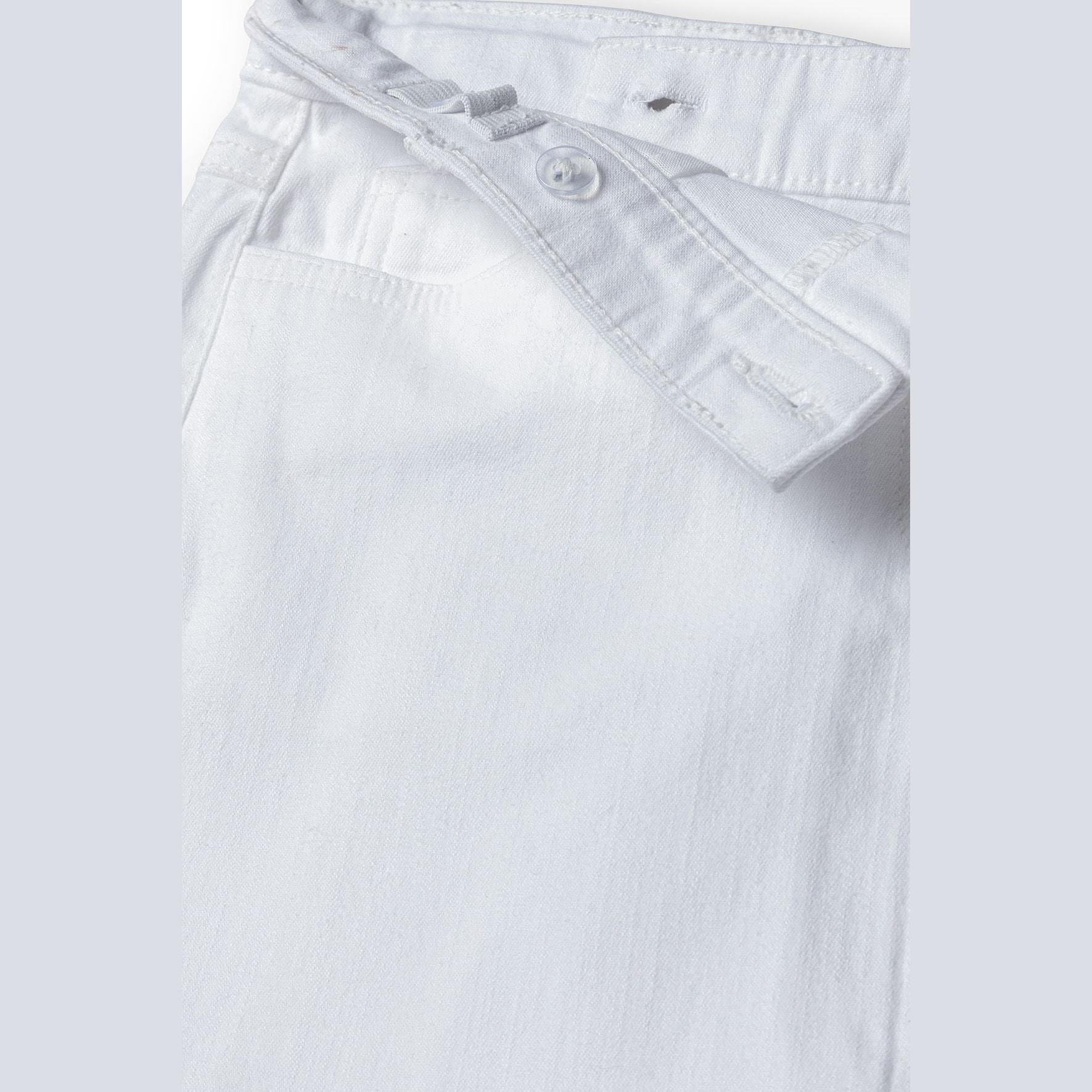 Close-up detail of white twill skirt showing texture and construction quality with focus on waistband and button closure
