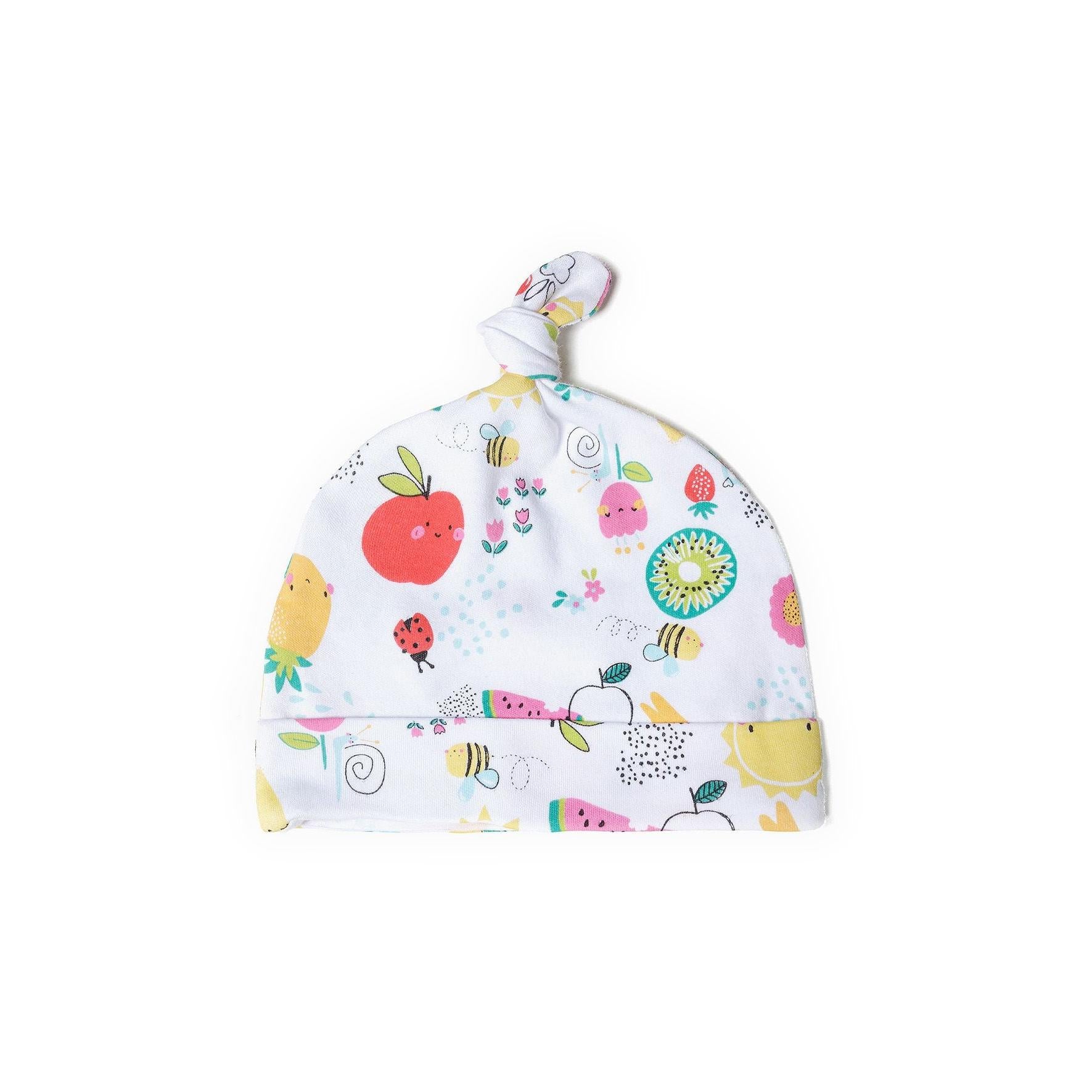 Single white baby hat with colorful all-over print featuring fruits, bees, flowers and other playful motifs, showing knotted top detail against white background
