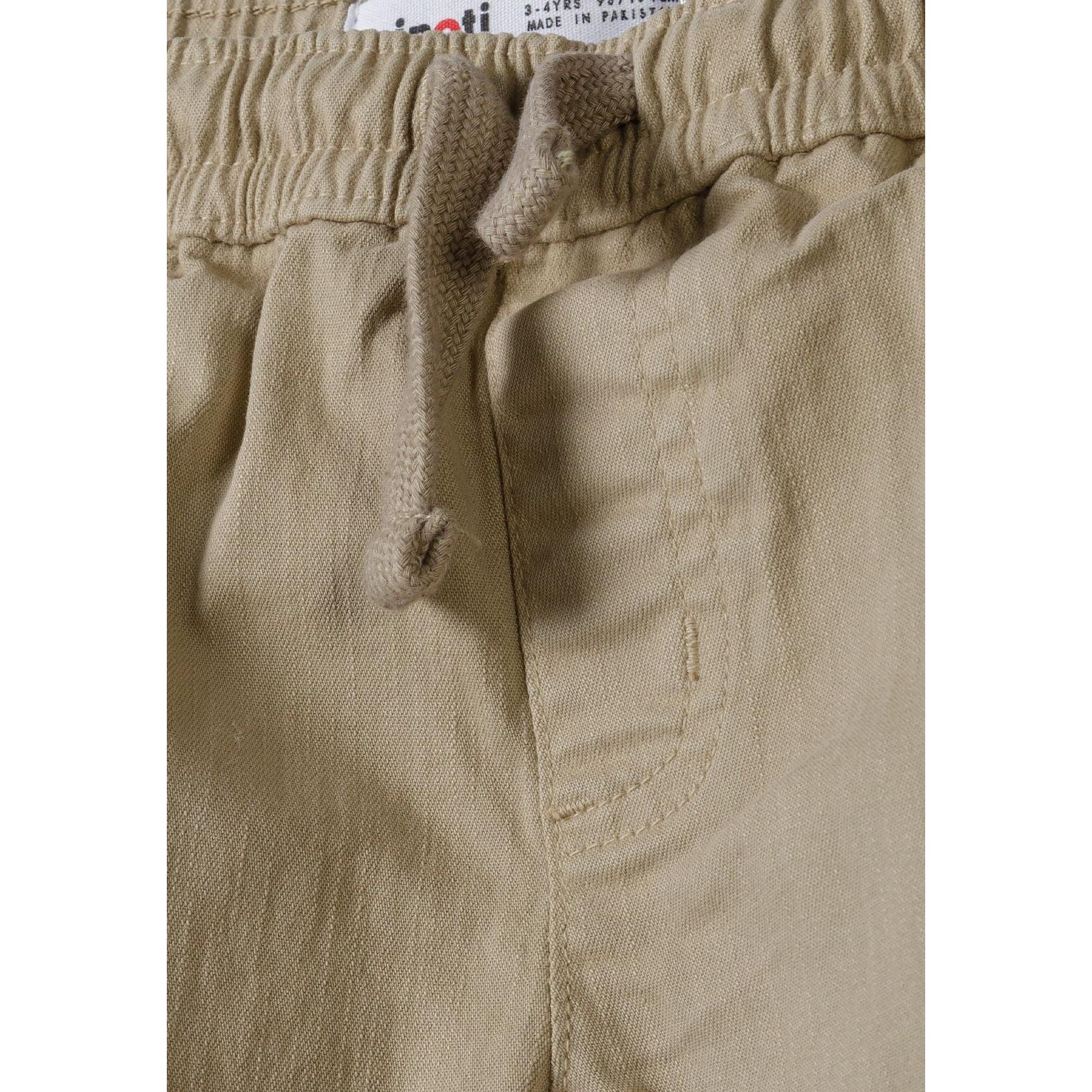 Close-up detail of elasticated waistband with beige drawstring and Minoti label visible