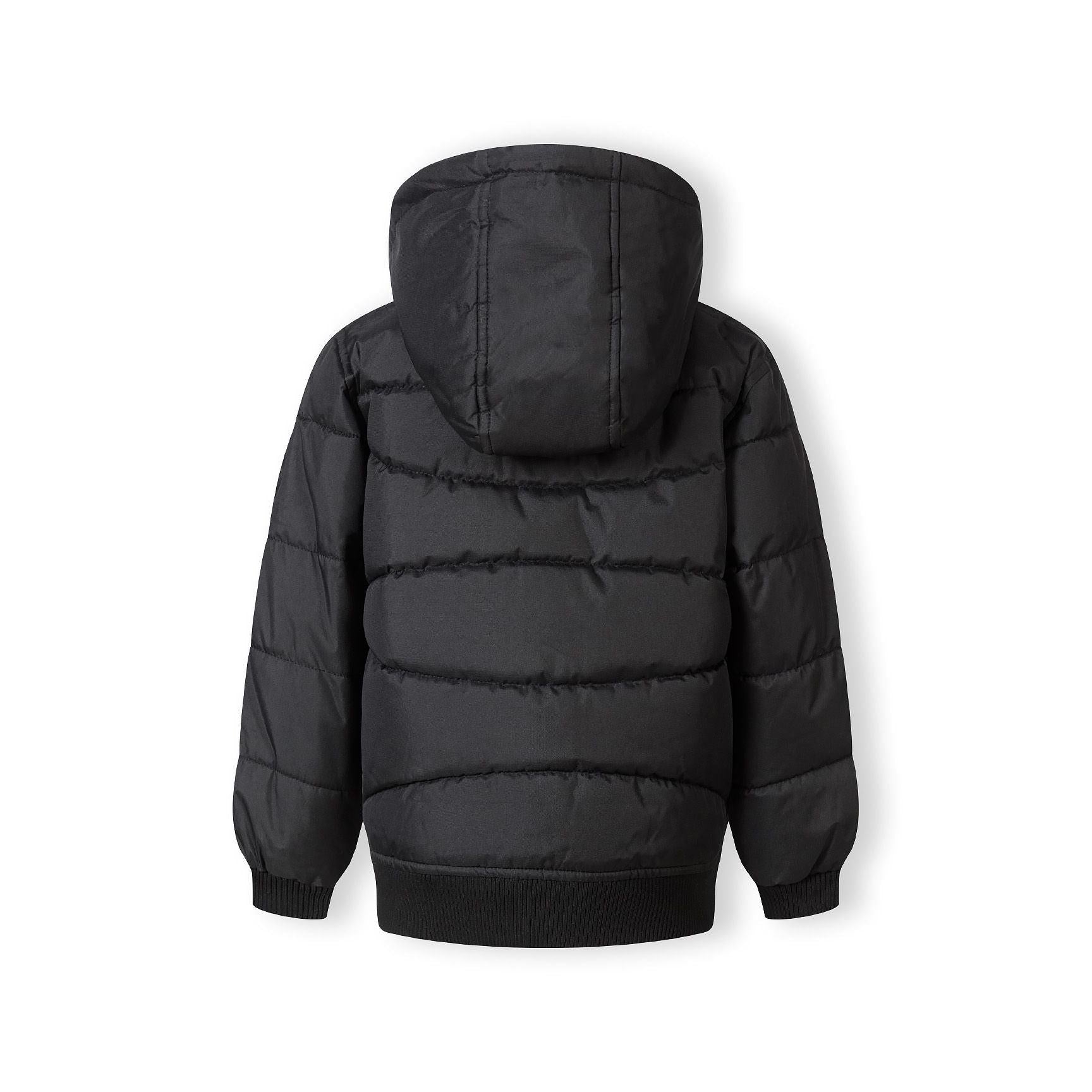 Close-up detail of black circular Minoti logo patch on the sleeve of the padded jacket showing MT 97 branding