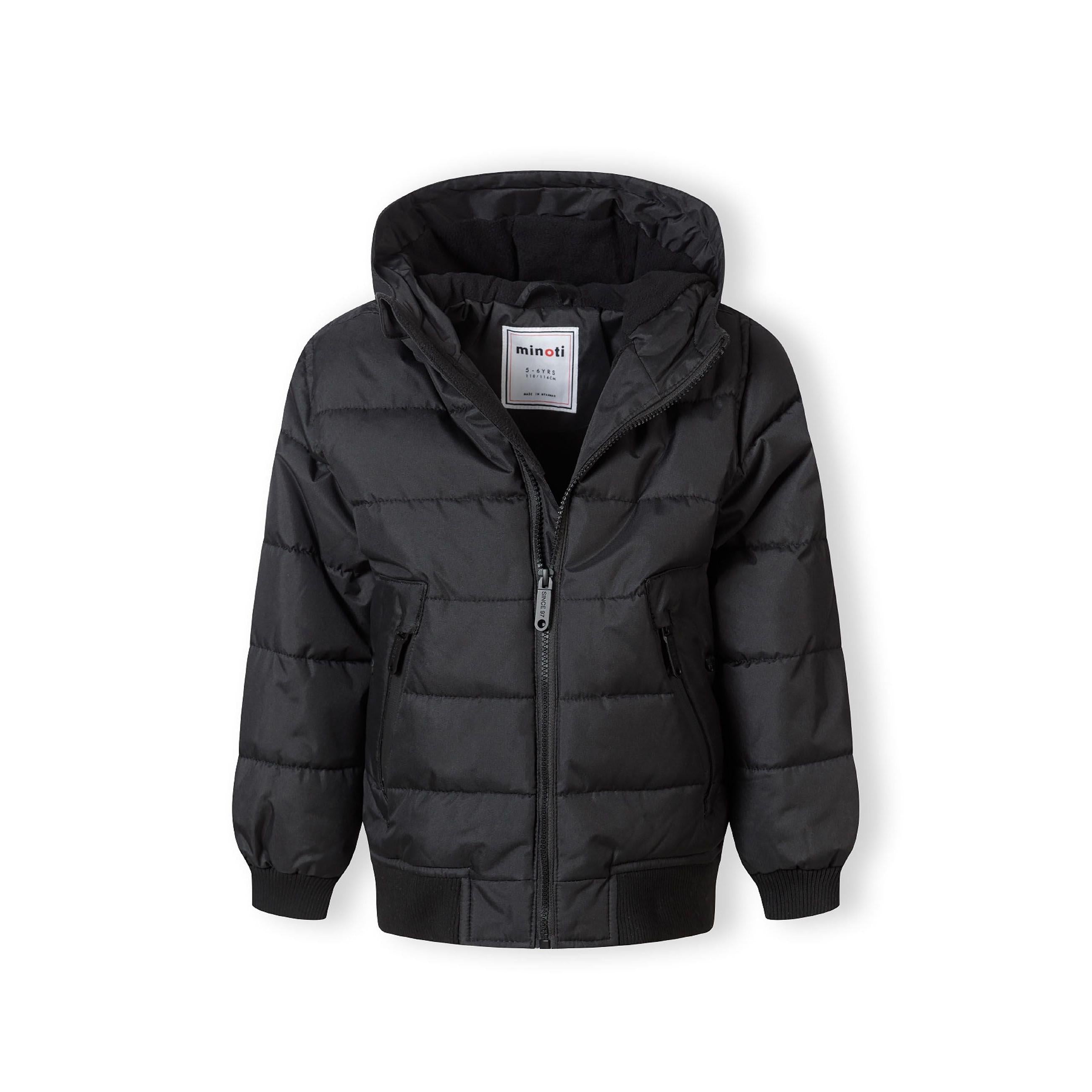 Close-up detail of black circular Minoti logo patch on the sleeve of the padded jacket showing MT 97 branding