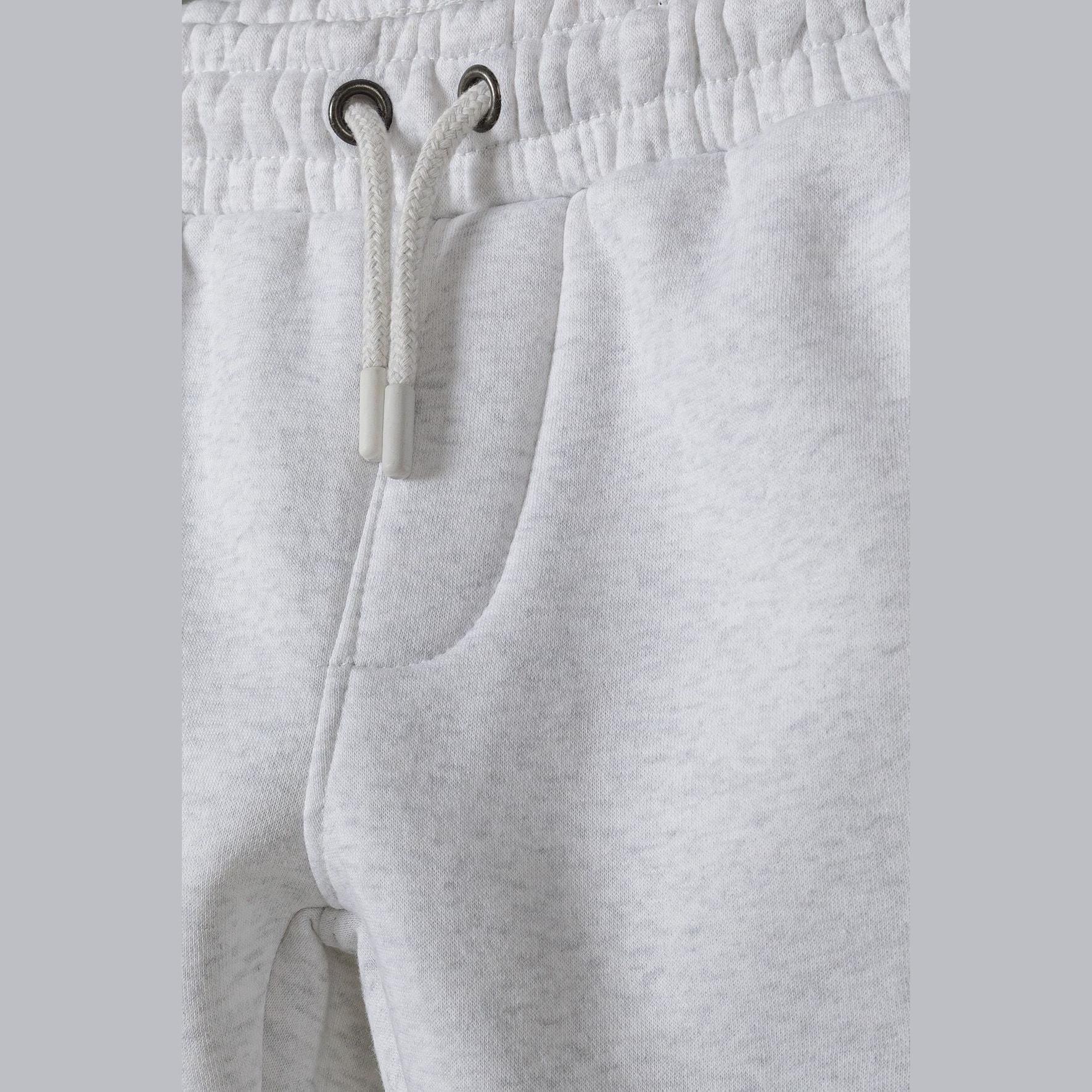 Close-up detail of grey joggers waistband showing drawstring ties and front pocket