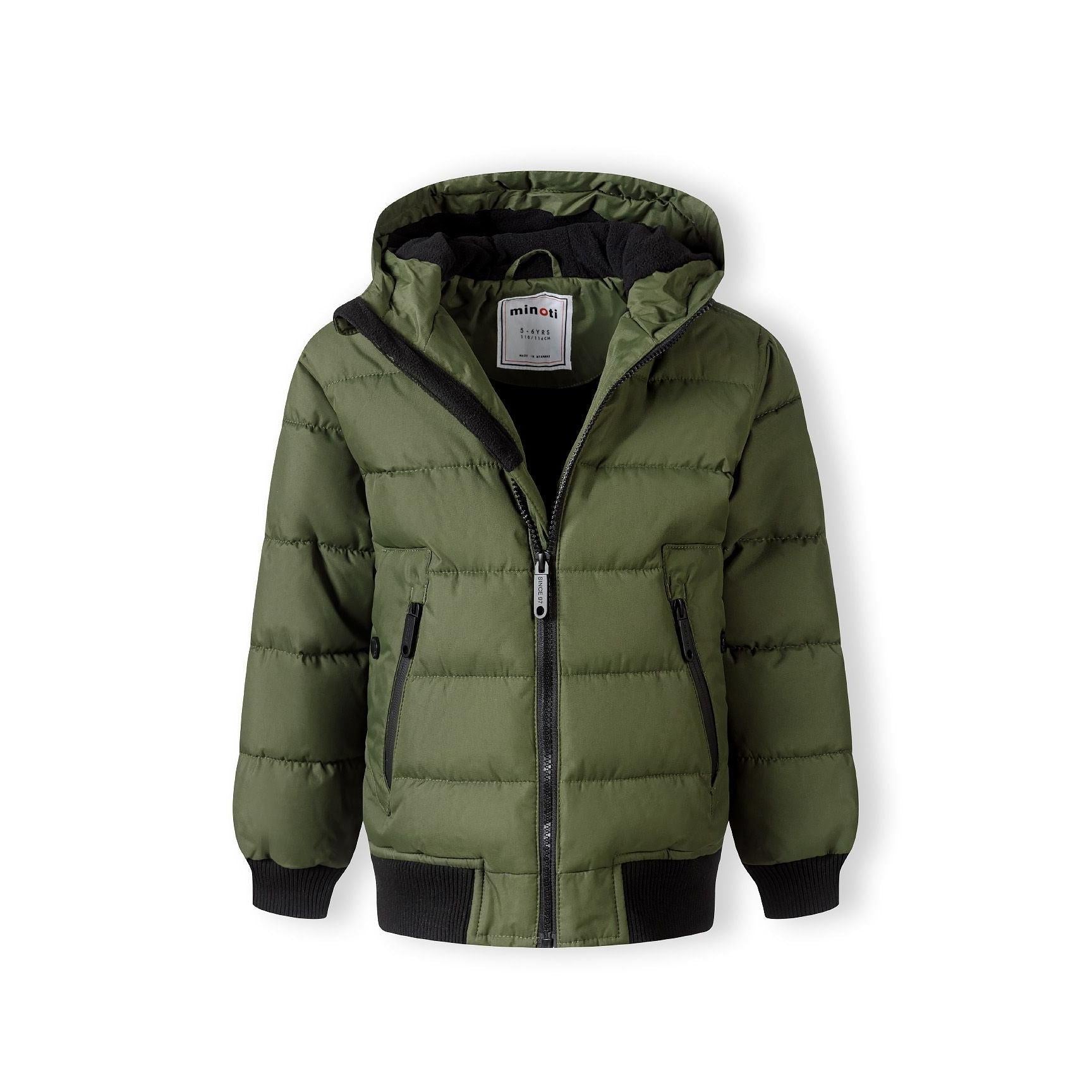 Close-up detail of khaki padded jacket showing circular black Minoti brand badge with crossed design and number 97