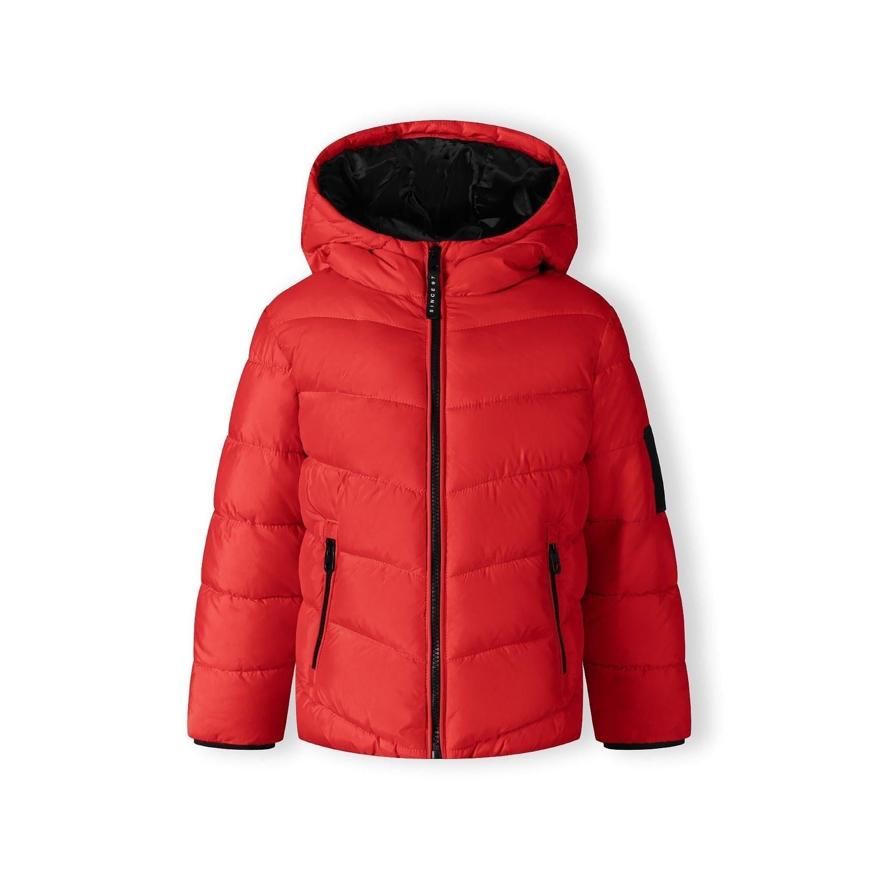 Same boy in red quilted jacket, front view showing full zip closure and side pockets with contrast details