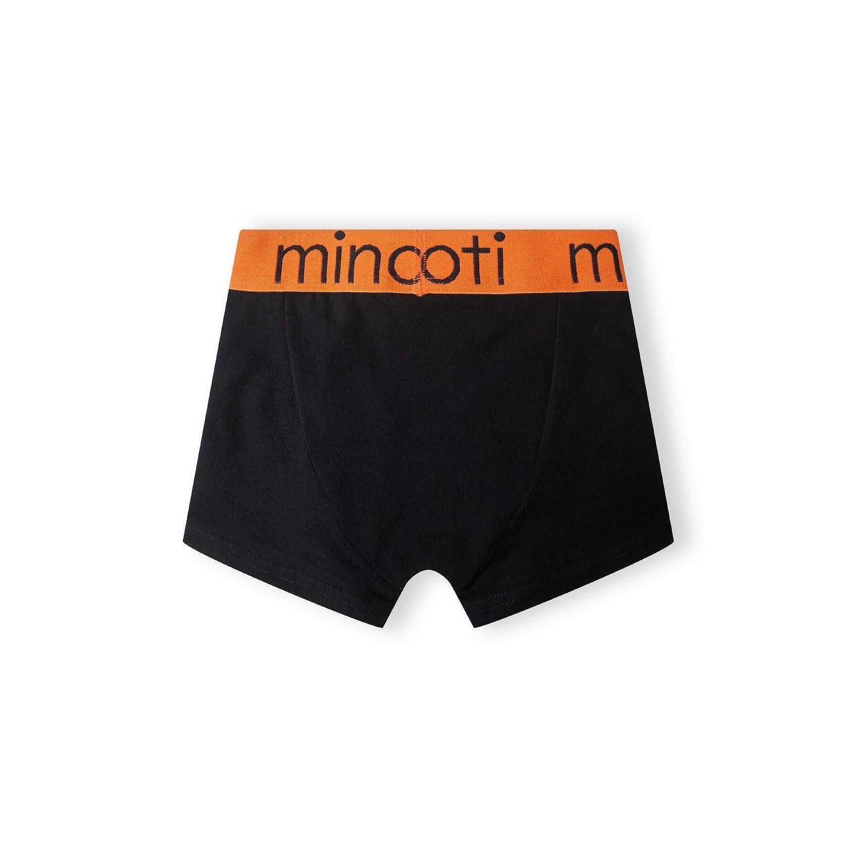 Single black trunk with orange waistband featuring Minoti branding, laid flat on white background displaying the comfortable fit and quality construction