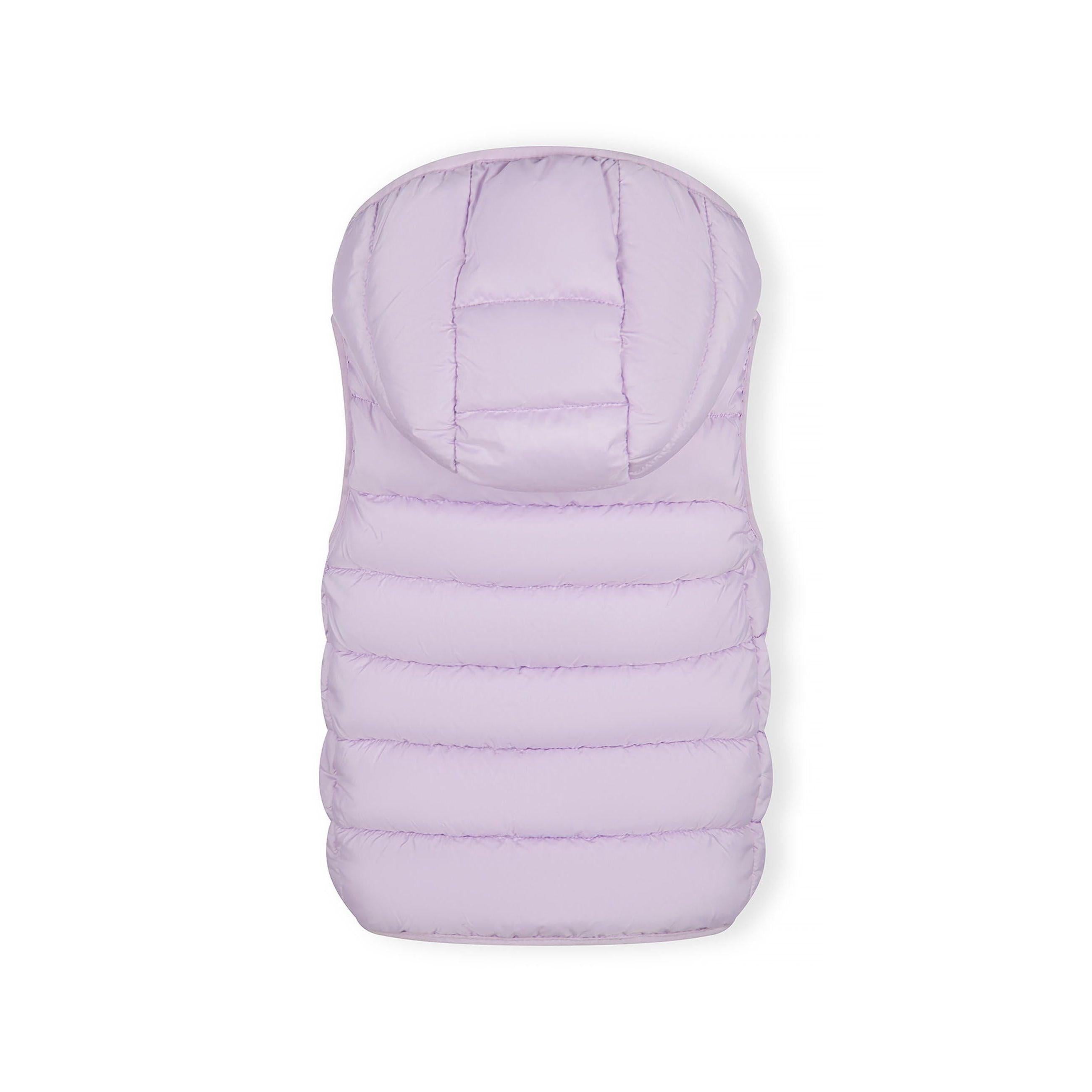 Young girl wearing lilac quilted gilet over navy tracksuit with white stripes, standing against grey background