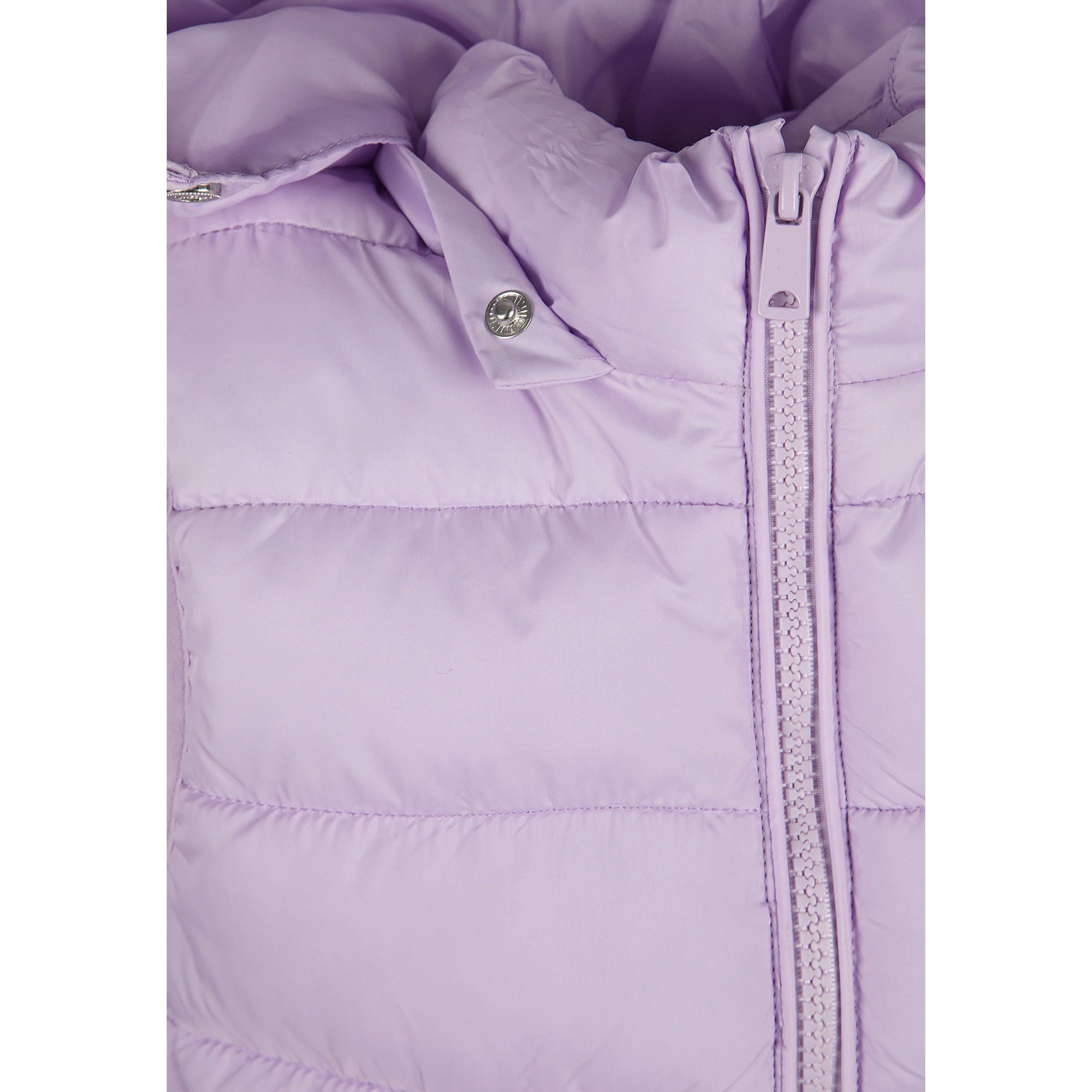 Close-up detail of lilac quilted fabric texture showing stitching pattern and Minoti brand label with glitter finish