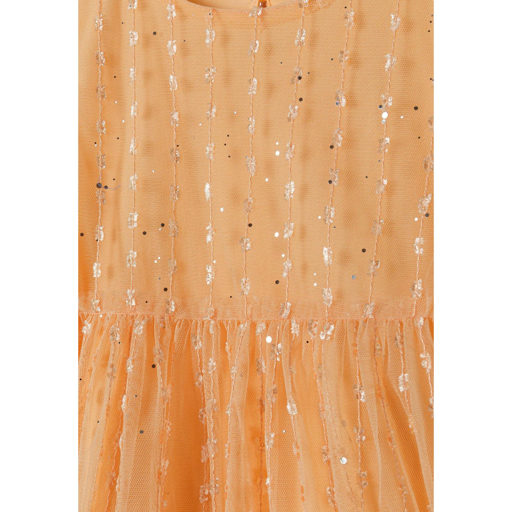 Close-up detail of orange sparkle tulle fabric showing textured surface with glittering sequins and mesh overlay creating shimmer effect