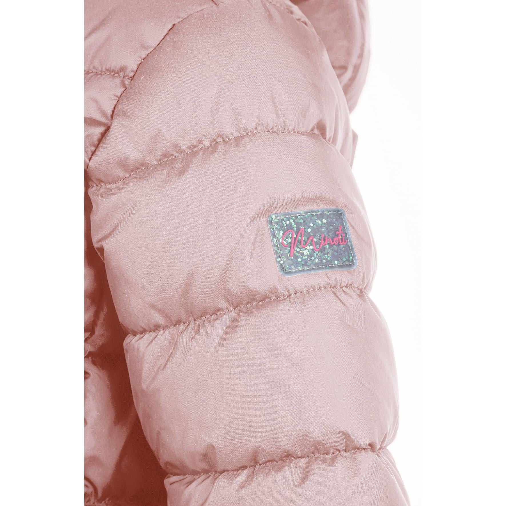 Detail view of pink quilted jacket fabric showing quilted texture, zip fastening and hood attachment