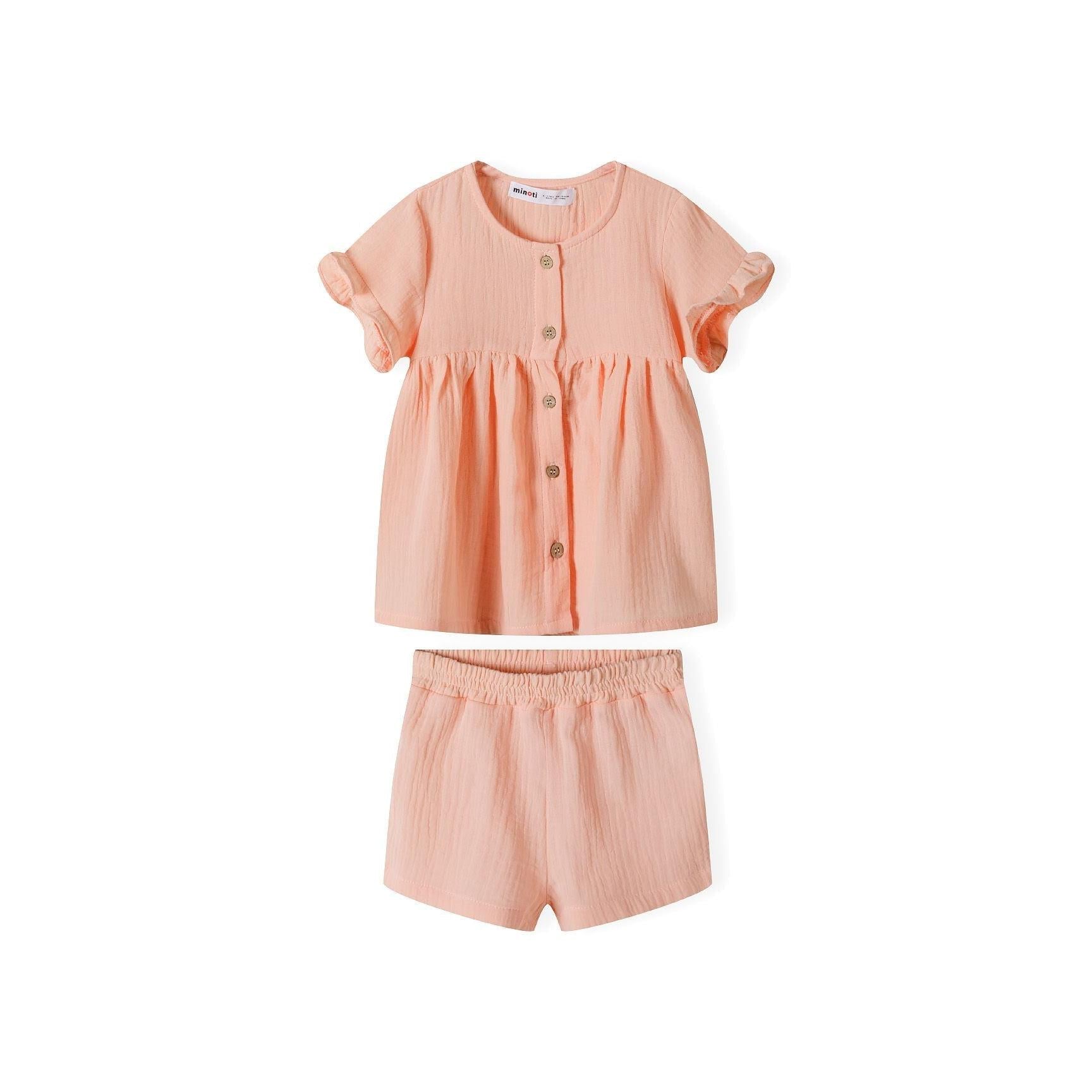 Back view of coral textured top with ruffle sleeves laid flat on white background showing gathered waistline detail