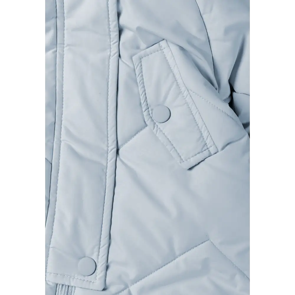 Detail view of light blue snowsuit foot section with elasticated ankle cuff and gathered fabric construction on white background