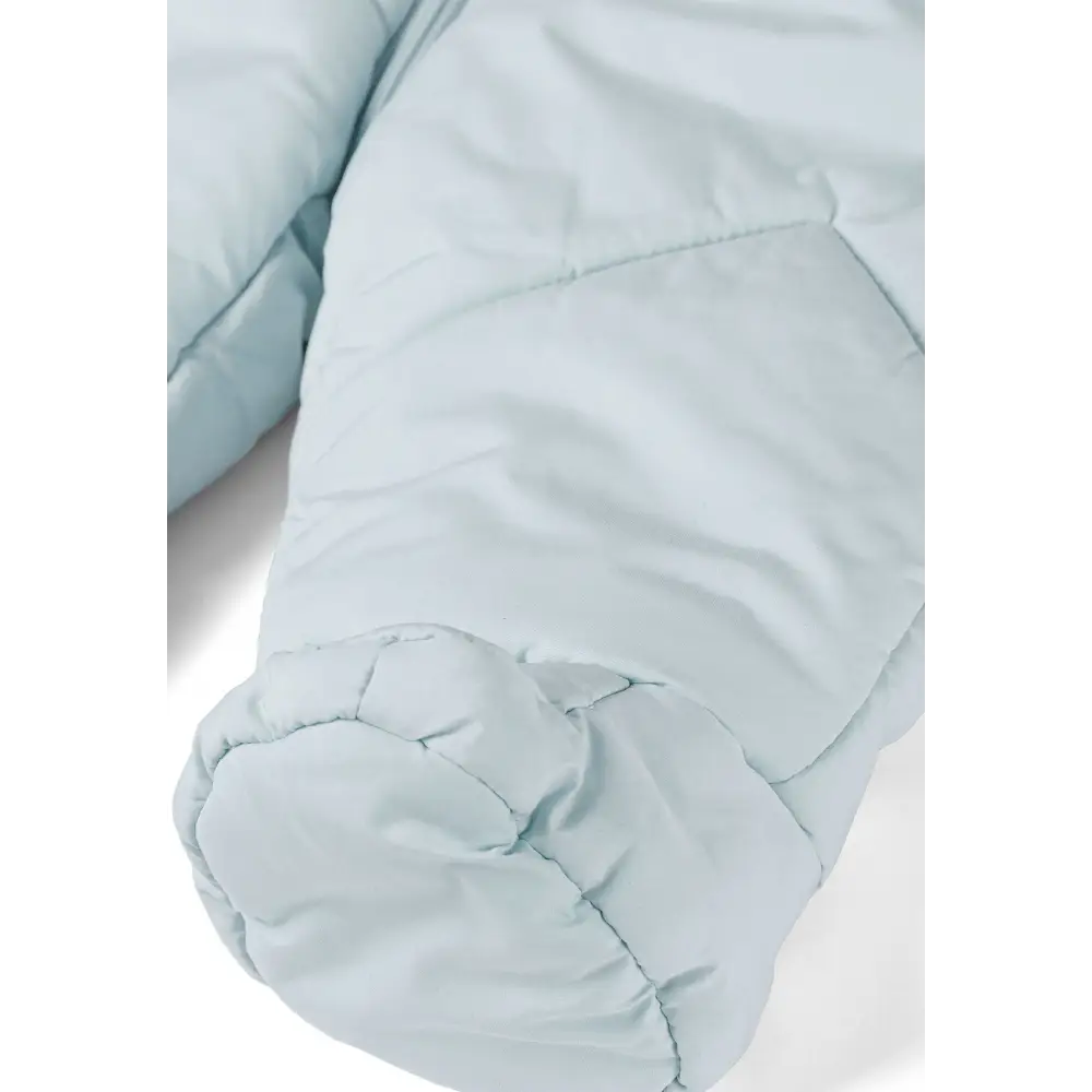 Close-up detail of light blue snowsuit showing integrated padded mitten with quilted texture and seam construction