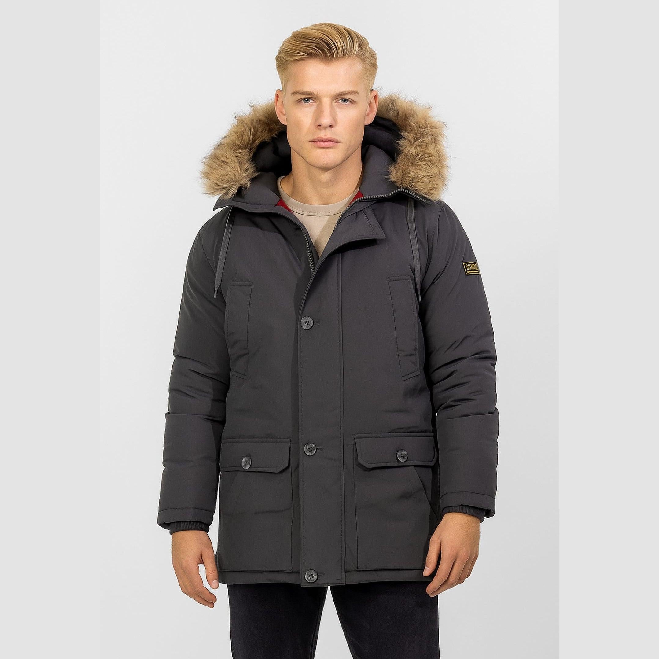 Front view of dark grey winter parka jacket on model with faux fur hood trim, multiple pockets and button closure against white background