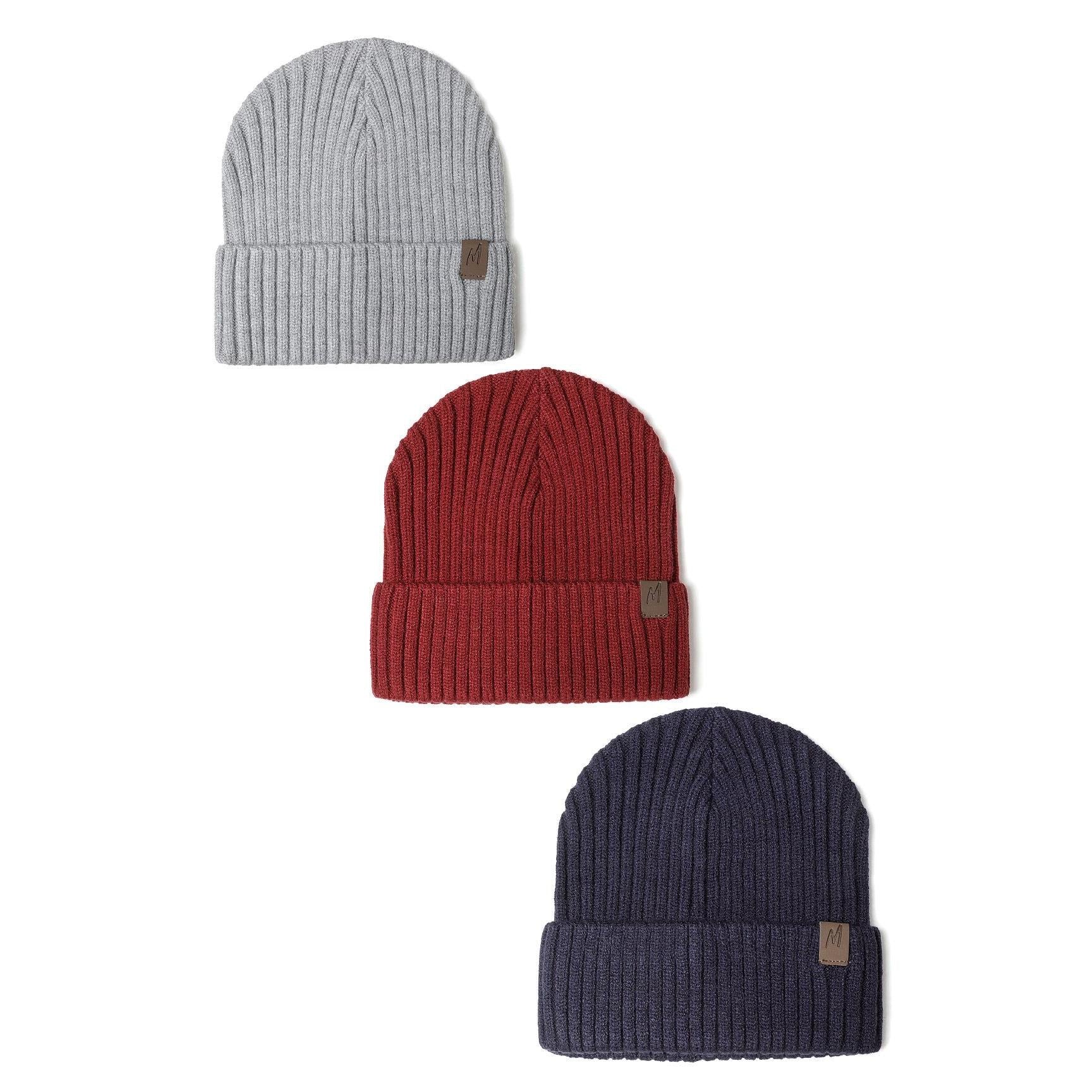 Three ribbed knit beanies displayed vertically on white background - light grey at top, burgundy red in middle, and navy blue at bottom, each featuring a small leather-look tab detail