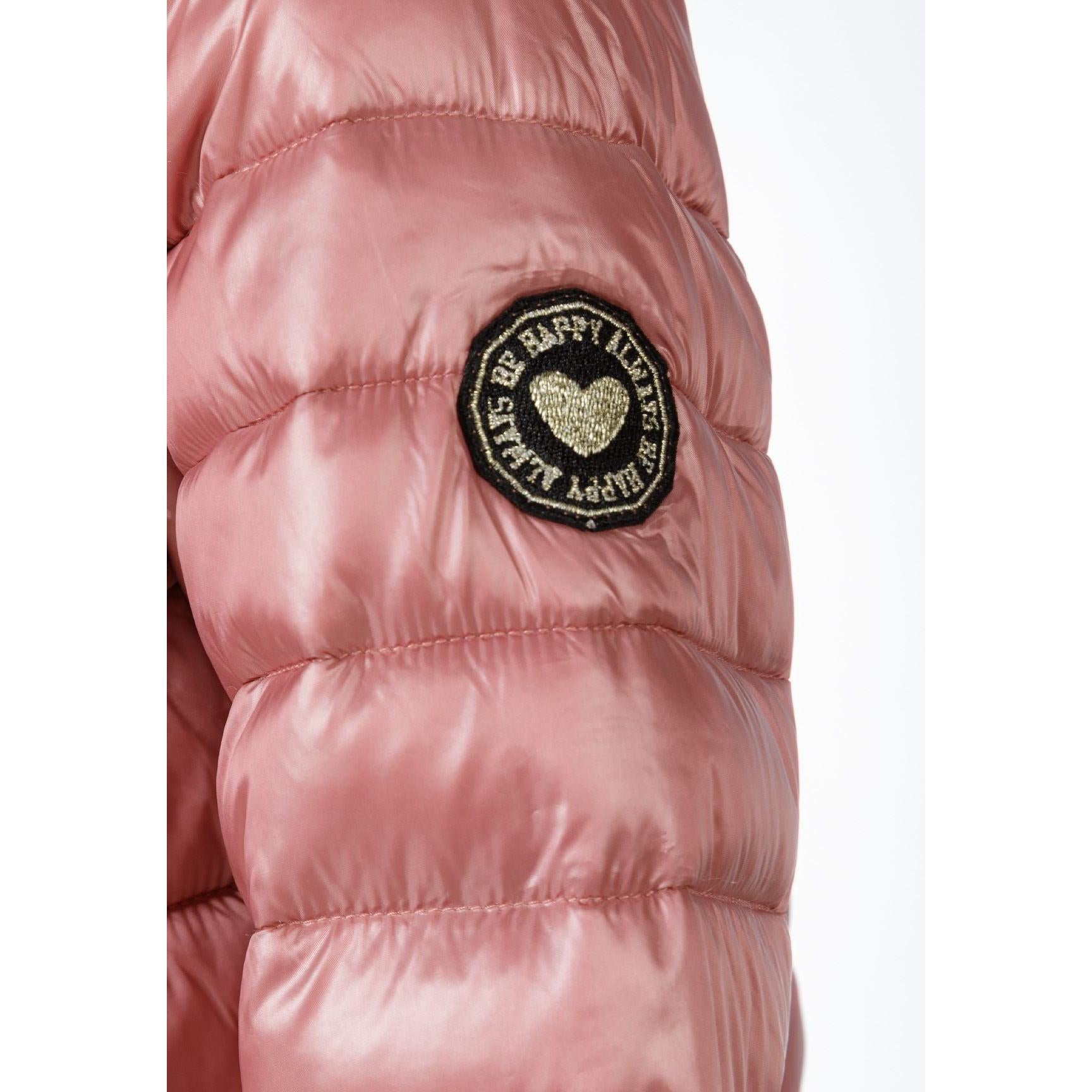 Close-up detail of copper quilted jacket sleeve showing circular embroidered patch with heart design and text