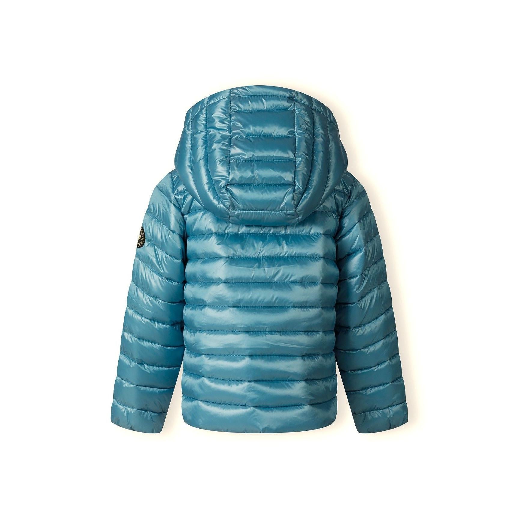 Close-up detail of circular embroidered patch with heart design on turquoise quilted fabric