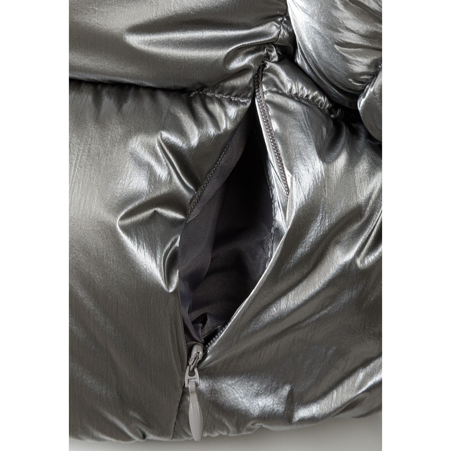 Close-up detail of grey metallic padded jacket showing front zip closure and quilted padding texture
