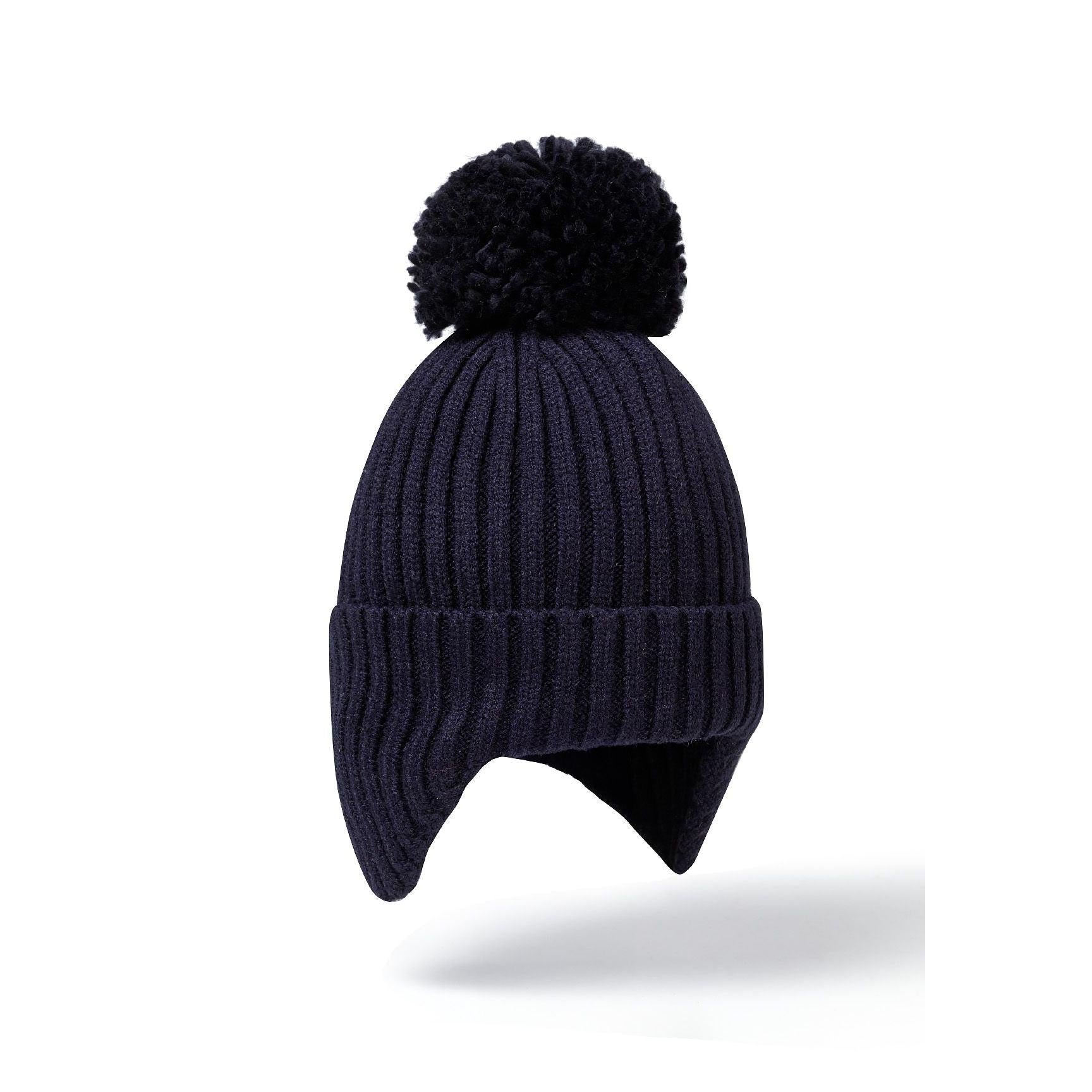 Navy knitted baby beanie with ear flaps and black pom pom shown against white background