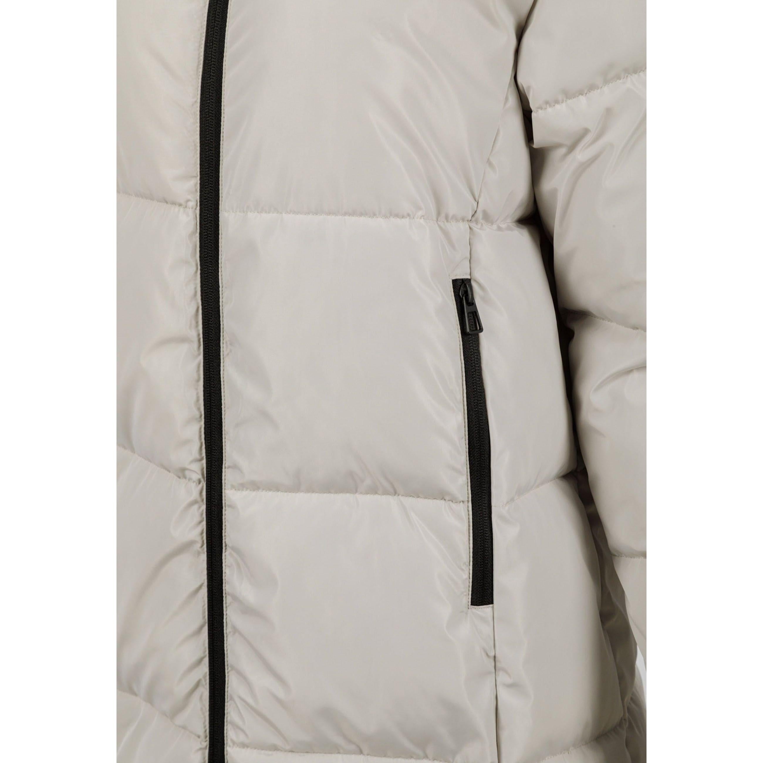 Close-up detail of cream quilted fabric showing padded construction and black zip pocket on the jacket