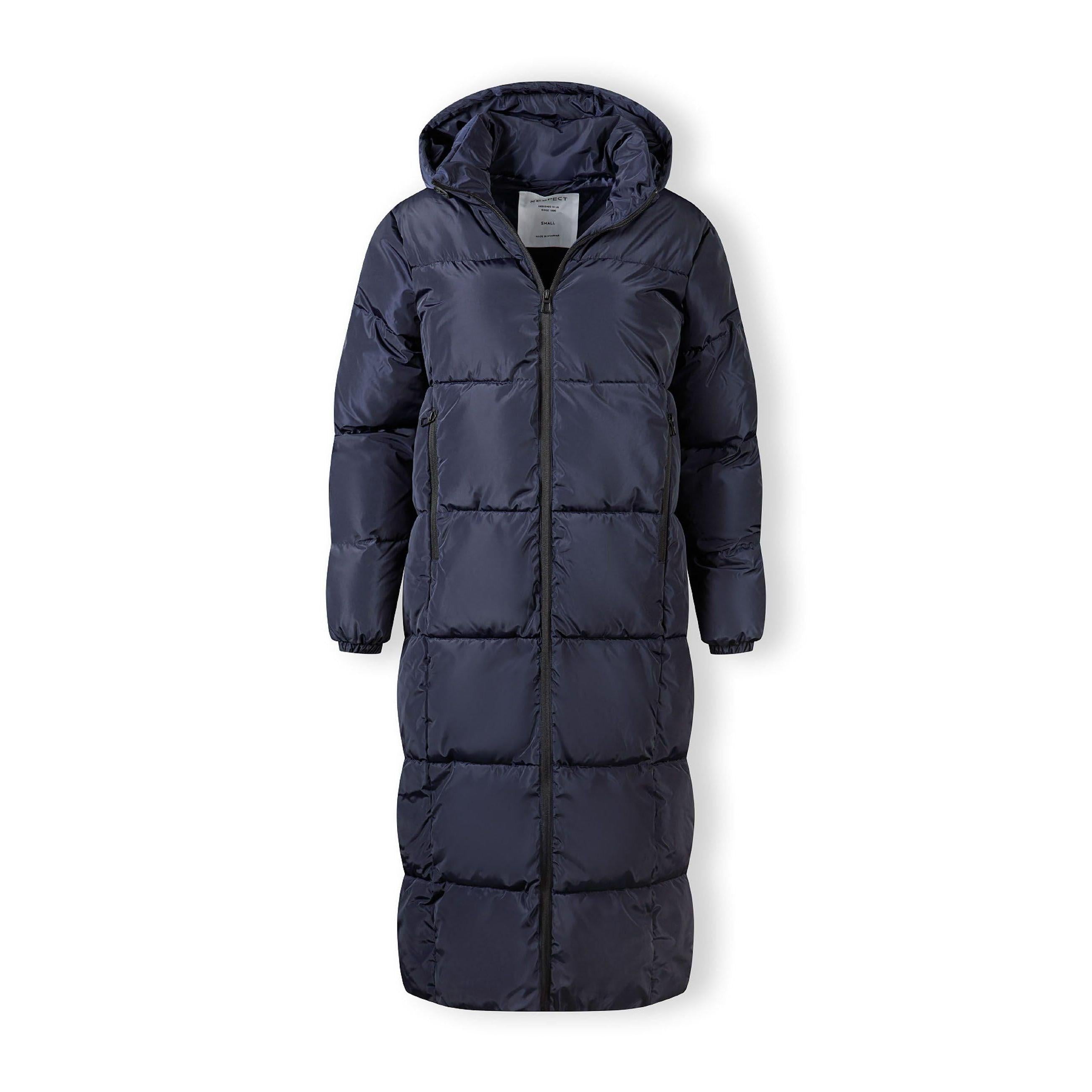 Close-up detail of navy quilted jacket showing zip fastening with black zipper pull on quilted fabric surface