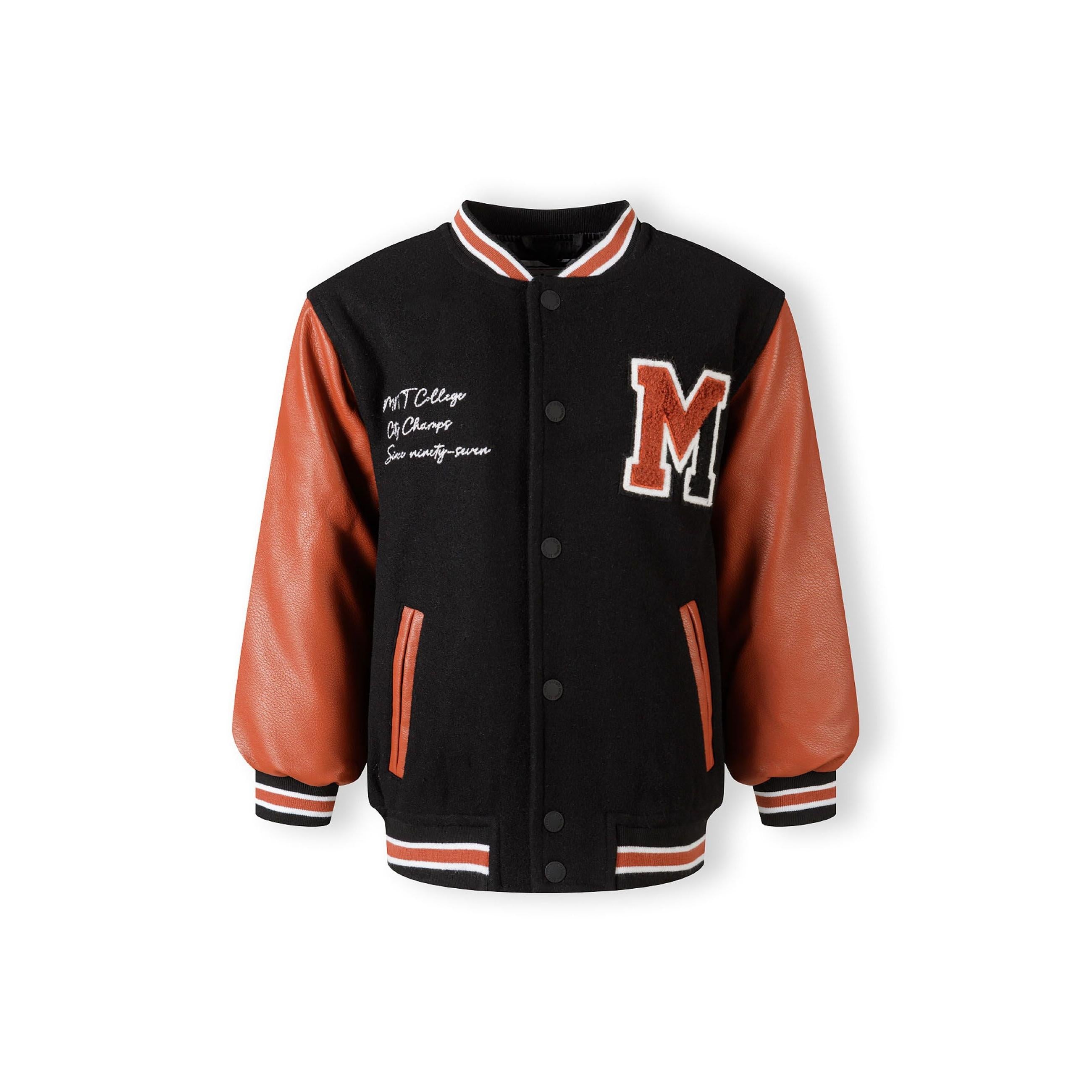 Back view of black varsity jacket showing quilted lining construction with orange PU sleeves and ribbed striped trim details on white background