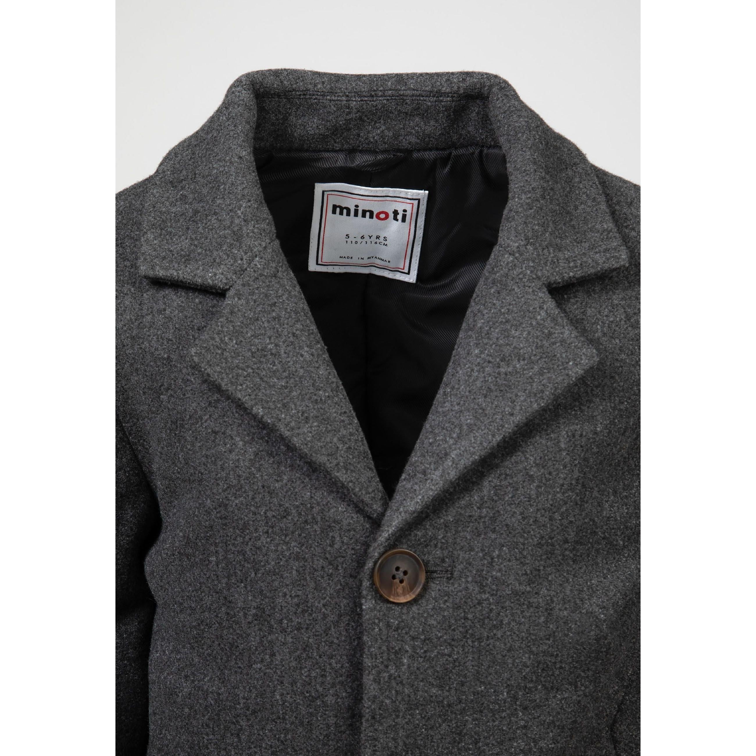 Close-up detail of grey coat collar showing Minoti label, mock horn button and black interior lining