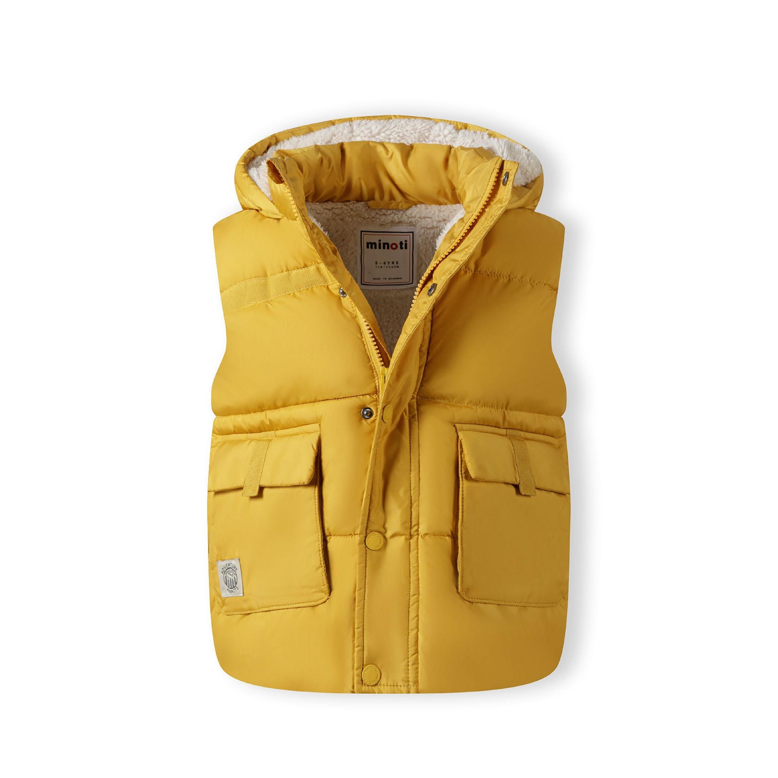 Front view of mustard yellow gilet laid flat showing zip closure, chest pockets, Minoti label and teddy lining on white background