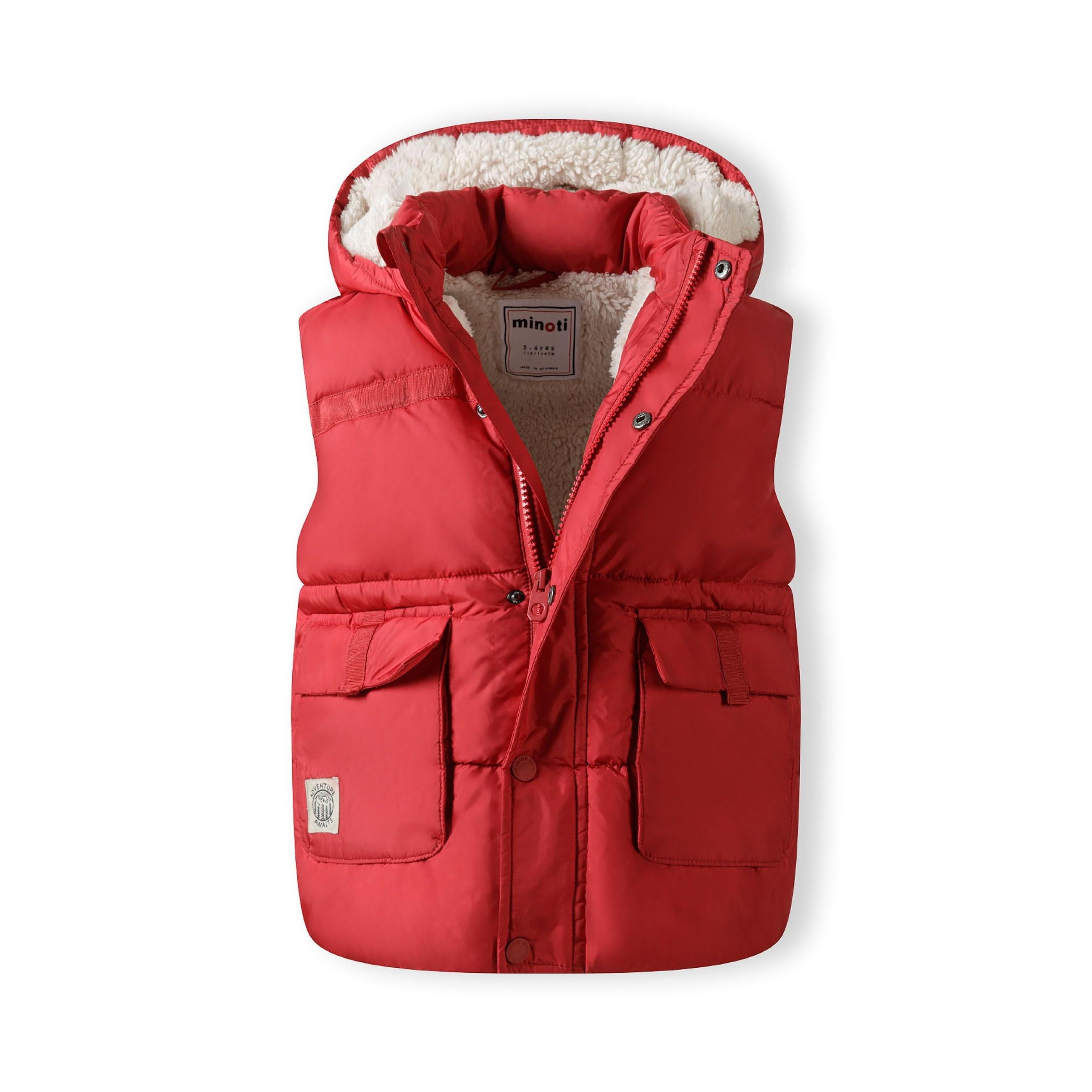 Red quilted gilet laid flat showing front view with hood, zip closure, chest pockets and teddy lining visible on white background