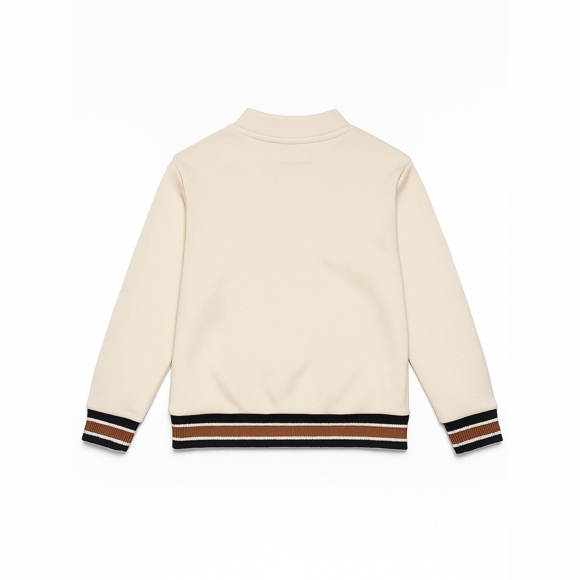 Back view of cream cardigan showing clean design with varsity-inspired ribbed hem and cuff details in navy, white and rust stripes