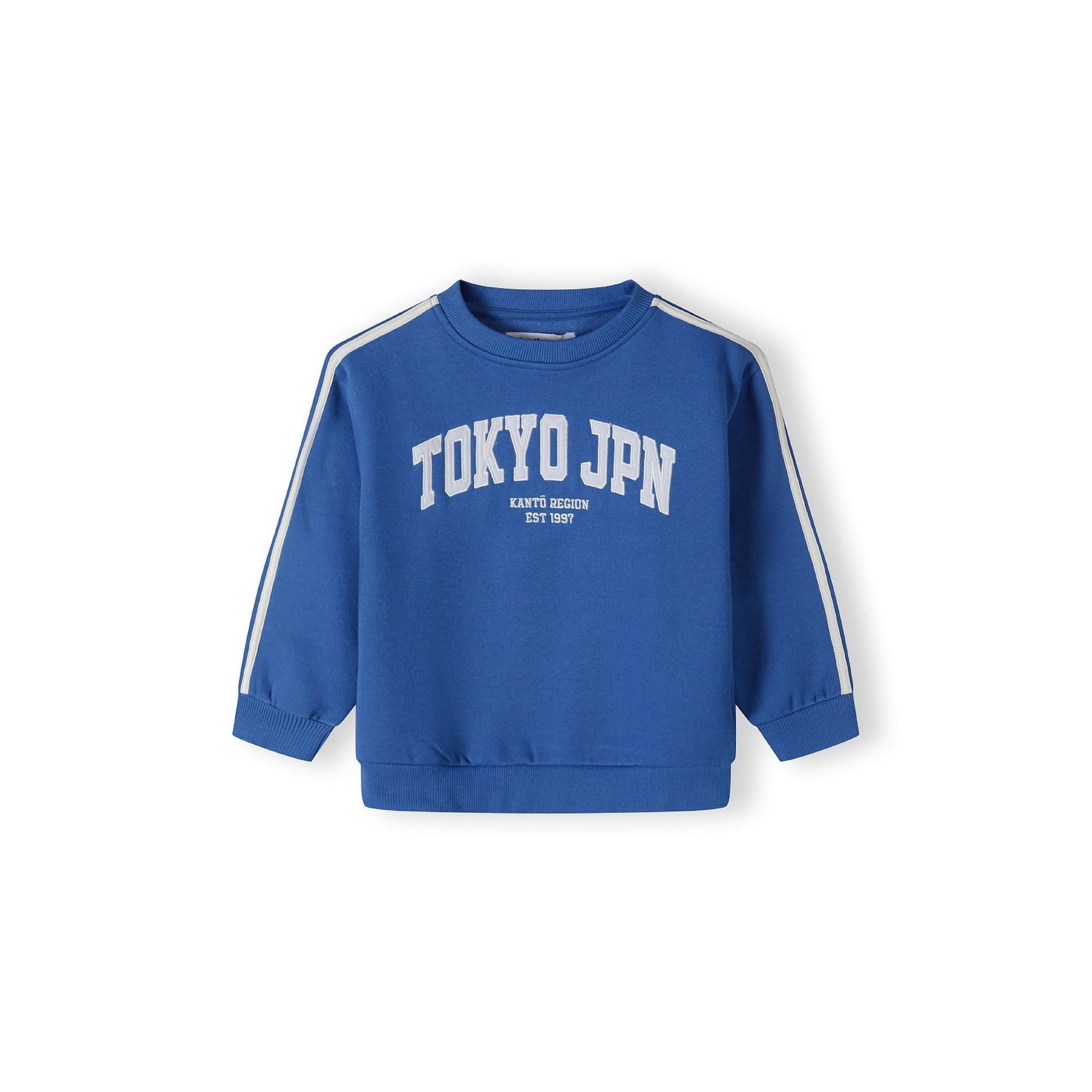 Close-up detail of cobalt blue joggers showing elasticated waistband with white drawstring ties