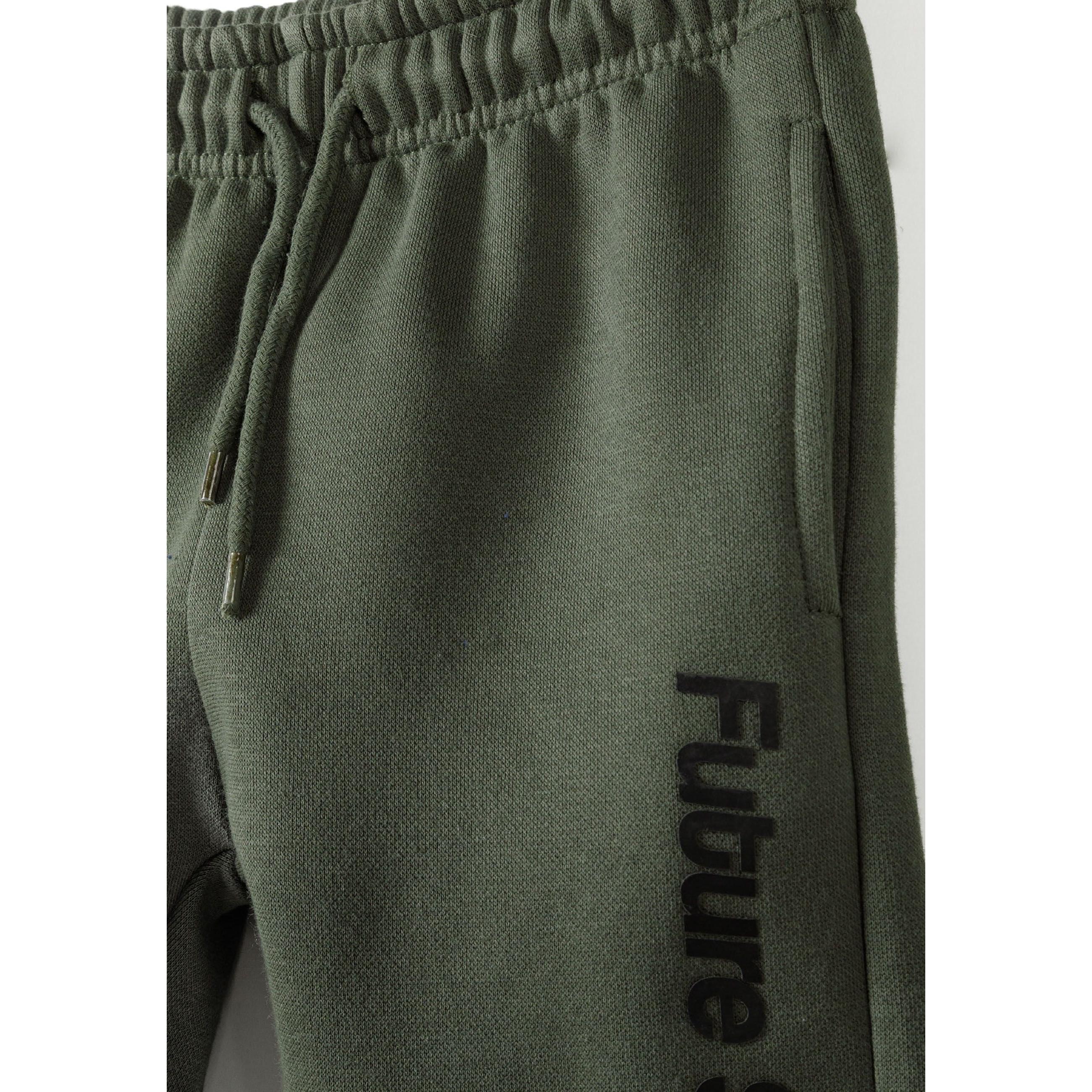 Close-up detail of khaki jogger pants showing drawstring waistband and Future Skate vertical text print on side seam
