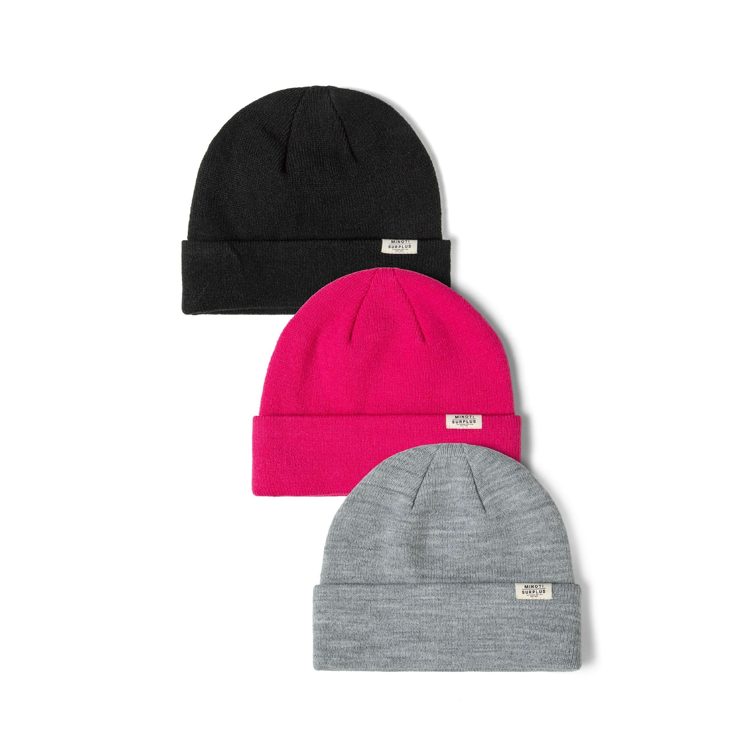 Three Minoti ribbed beanie hats arranged on white background - black at top, bright pink in middle, grey at bottom, each with white surplus label