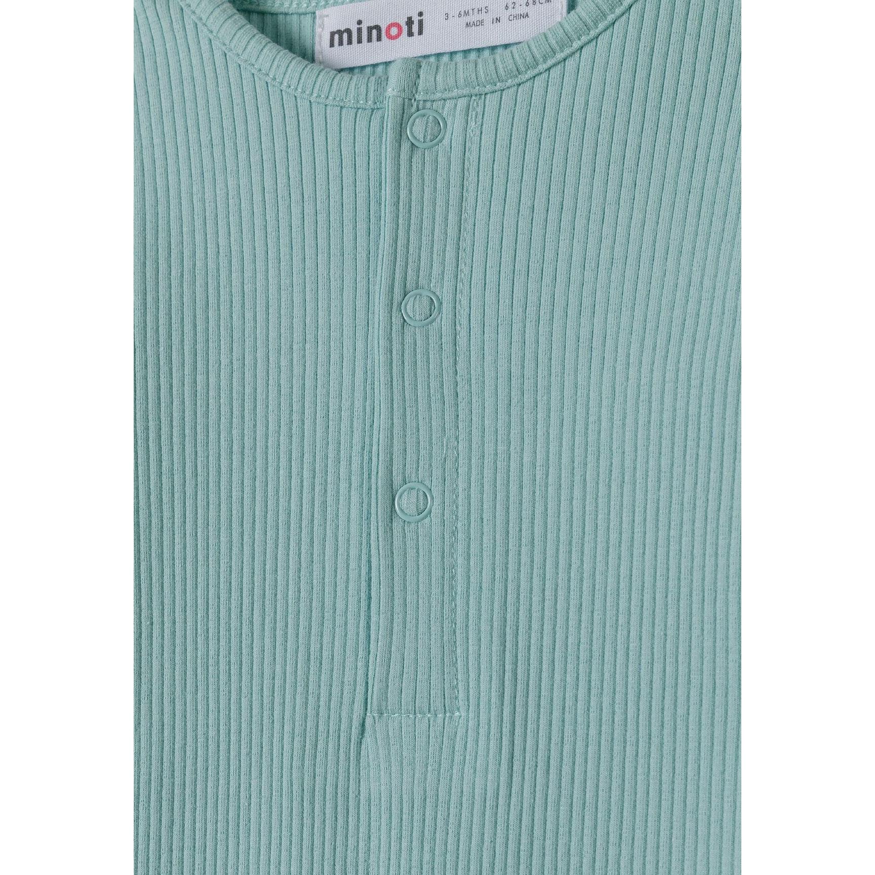 Close-up detail of sage green ribbed romper displaying Minoti brand label and front snap button closure design