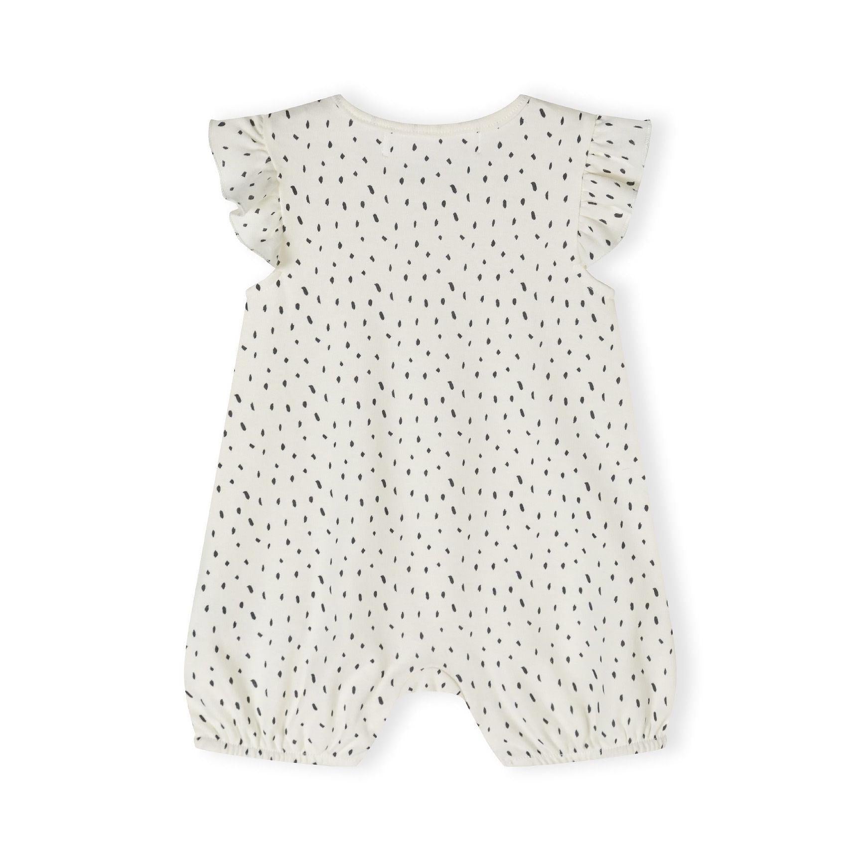 Back view of cream romper with black dot pattern showing flutter sleeve detail and snap button closures at crotch area