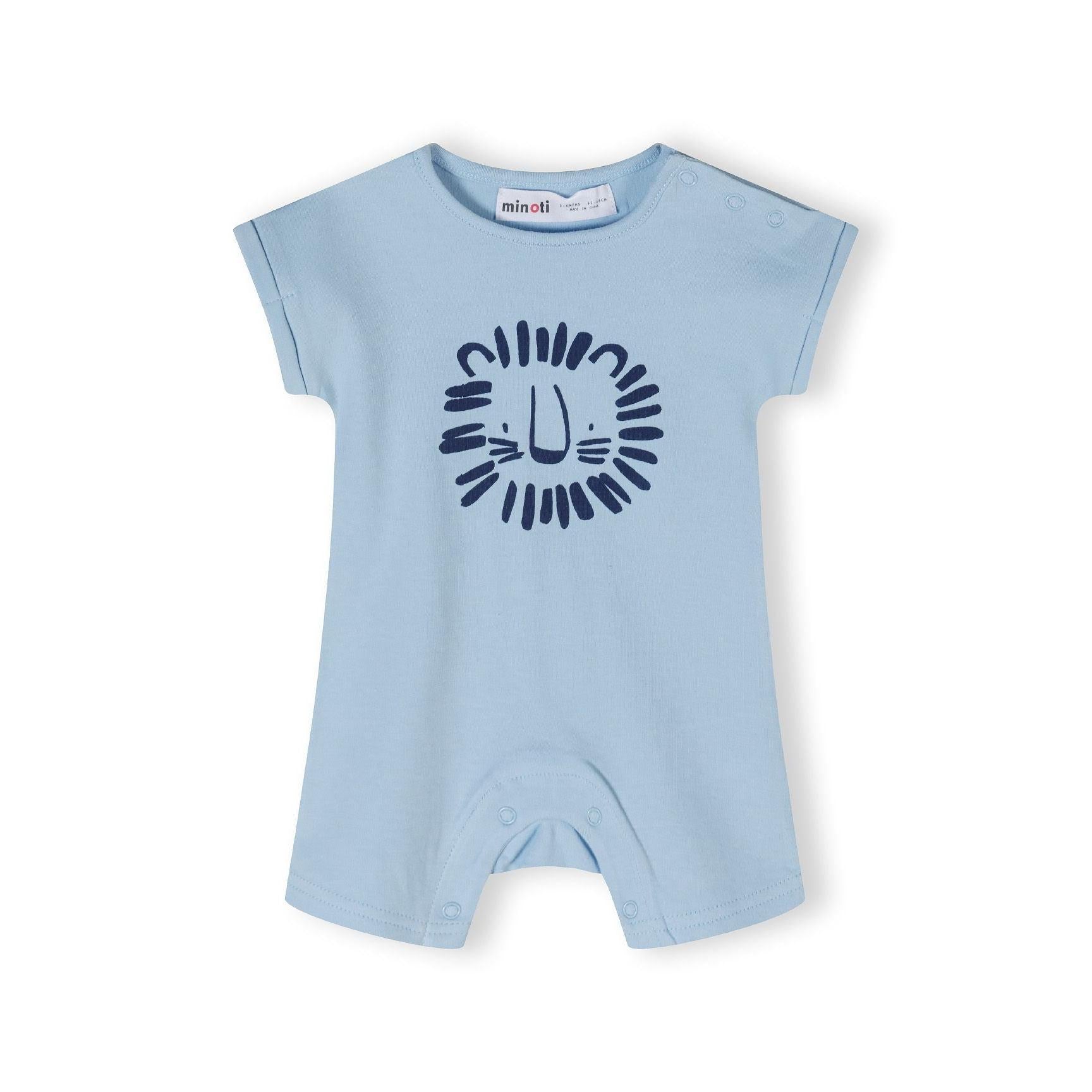 Close-up detail of safari print romper showing colorful animal pattern with giraffes, elephants, and lions in orange, blue and navy on cream background