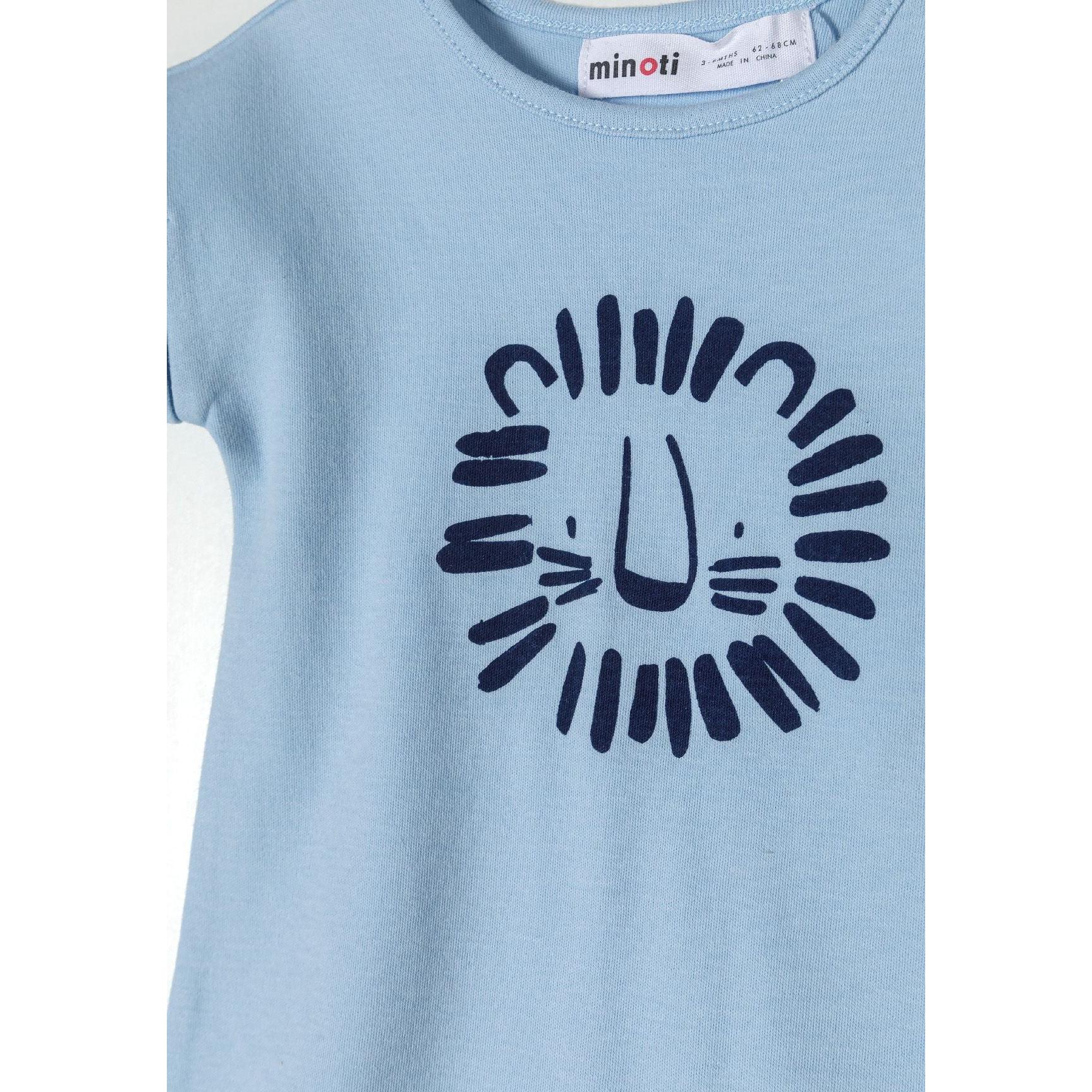 Close-up detail of safari print romper showing colorful animal pattern with giraffes, elephants, and lions in orange, blue and navy on cream background