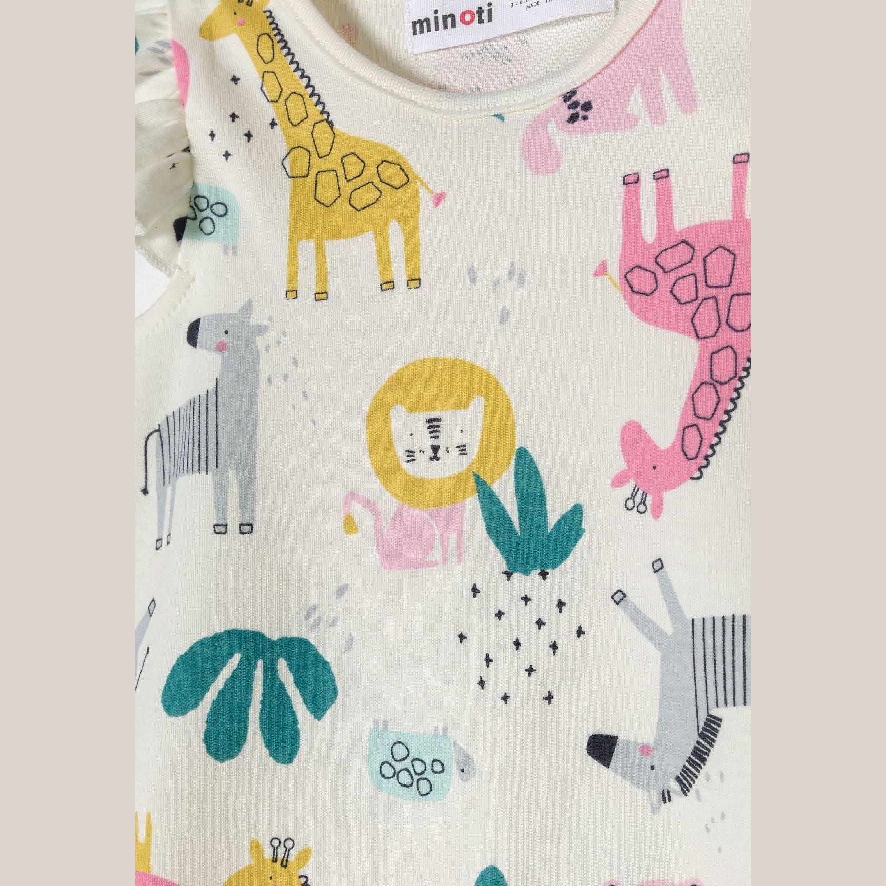 Close-up detail of cream safari print romper showing colorful giraffes, lions, elephants and decorative elements on white background