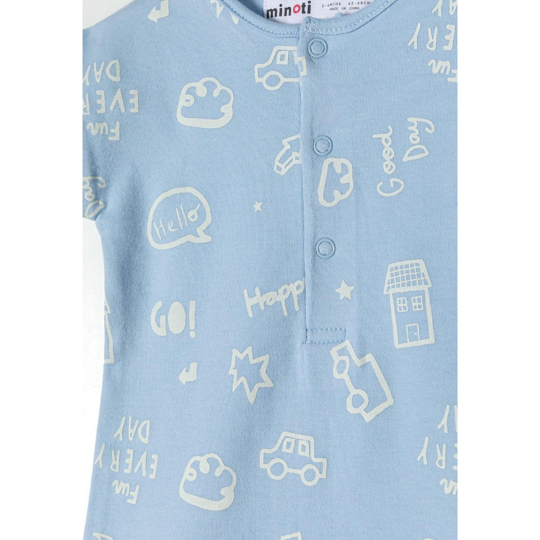 Close-up detail of light blue romper showing snap button closure and white printed design including cars, houses, stars and Hello text