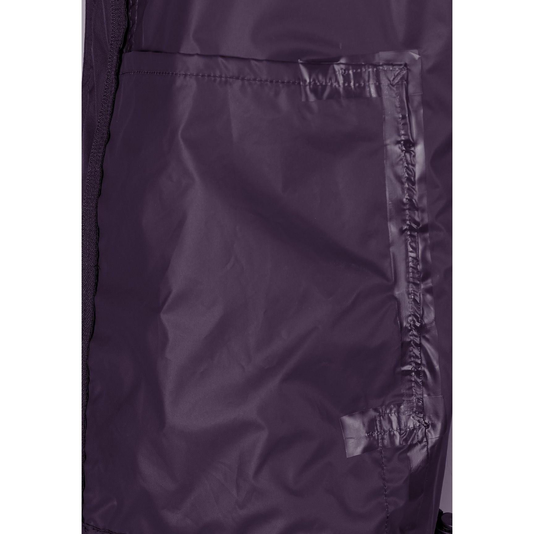 Close-up detail of purple waterproof jacket showing pocket construction and fabric texture