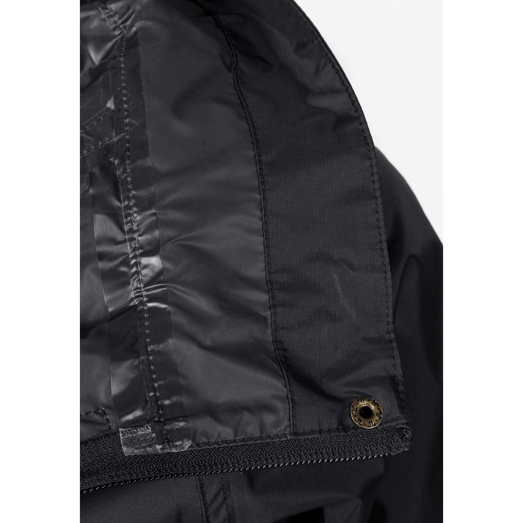 Close-up interior view of black waterproof jacket showing internal pockets and construction details